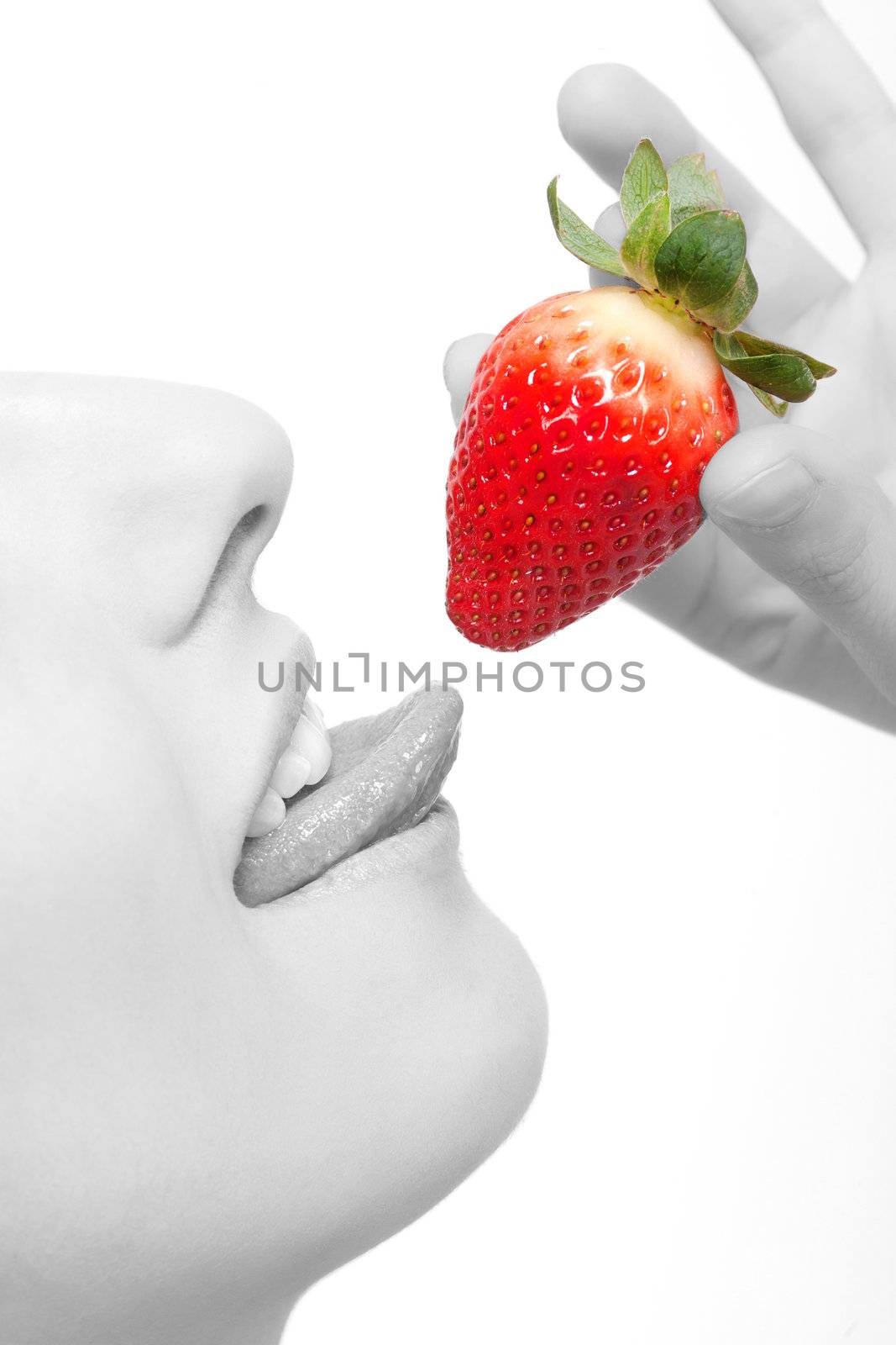 close-up woman�s lips and a strawberry