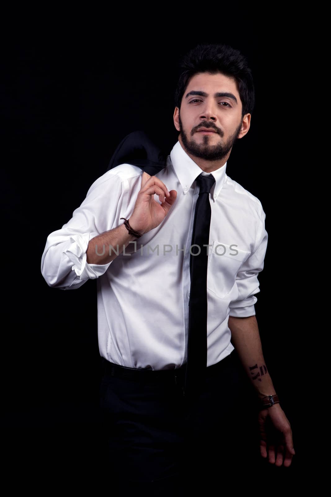 young successful business man with a suit isolated on black background