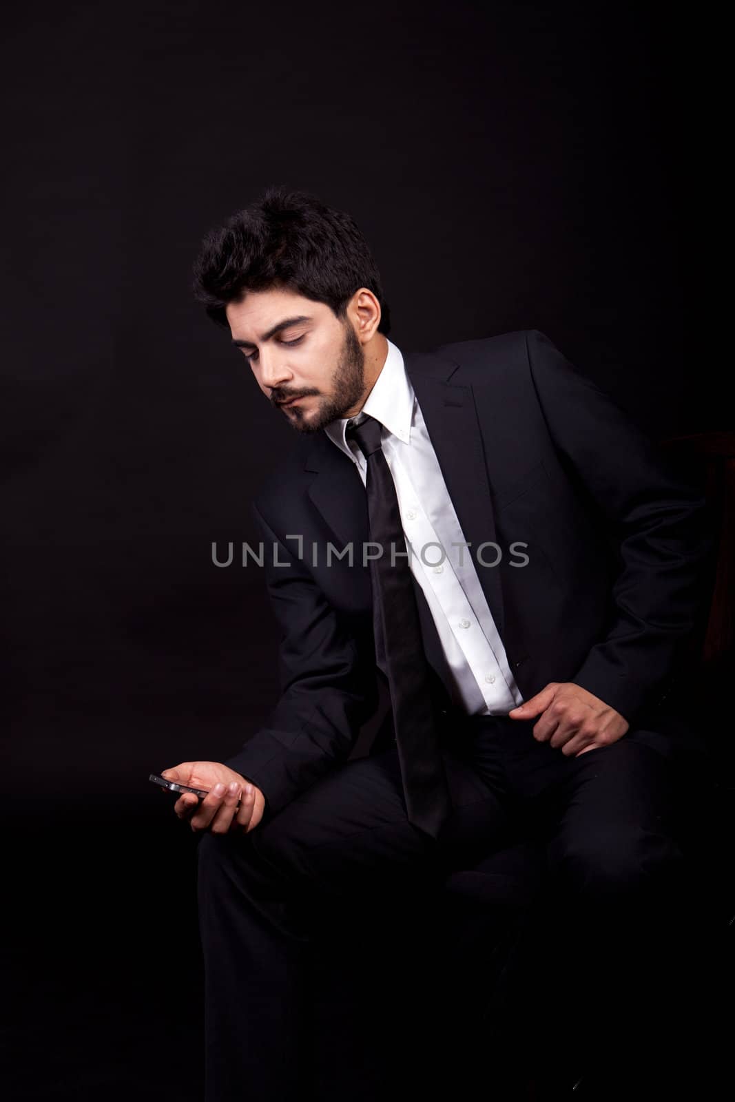 young successful business man with a suit isolated on black background by juniart
