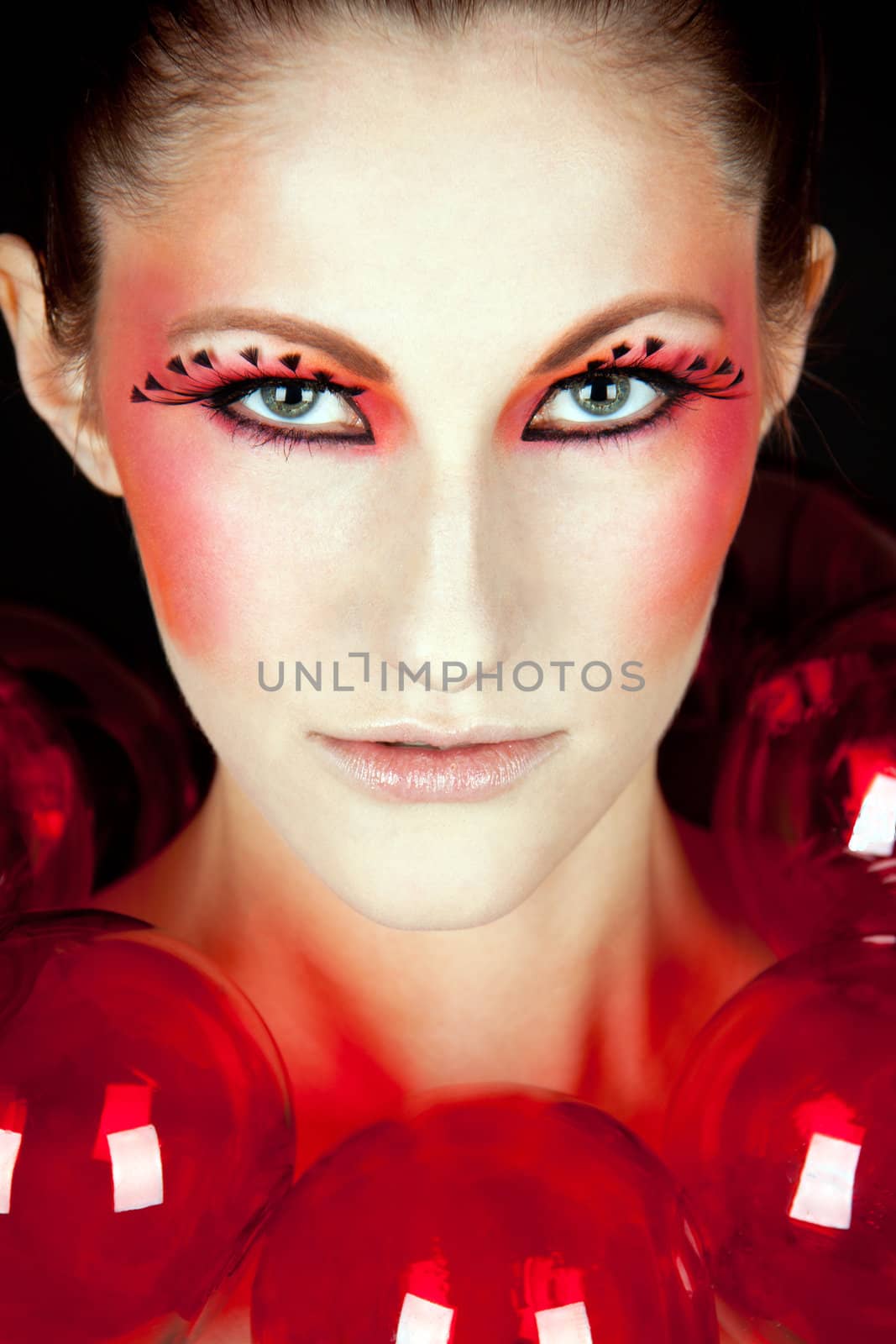 young beautiful woman with an extreme colorfull make up portrait