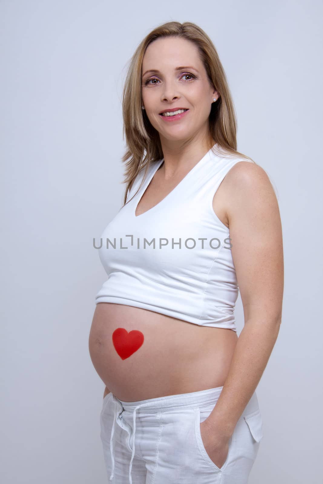 older pregnant woman looks forward to her baby by juniart