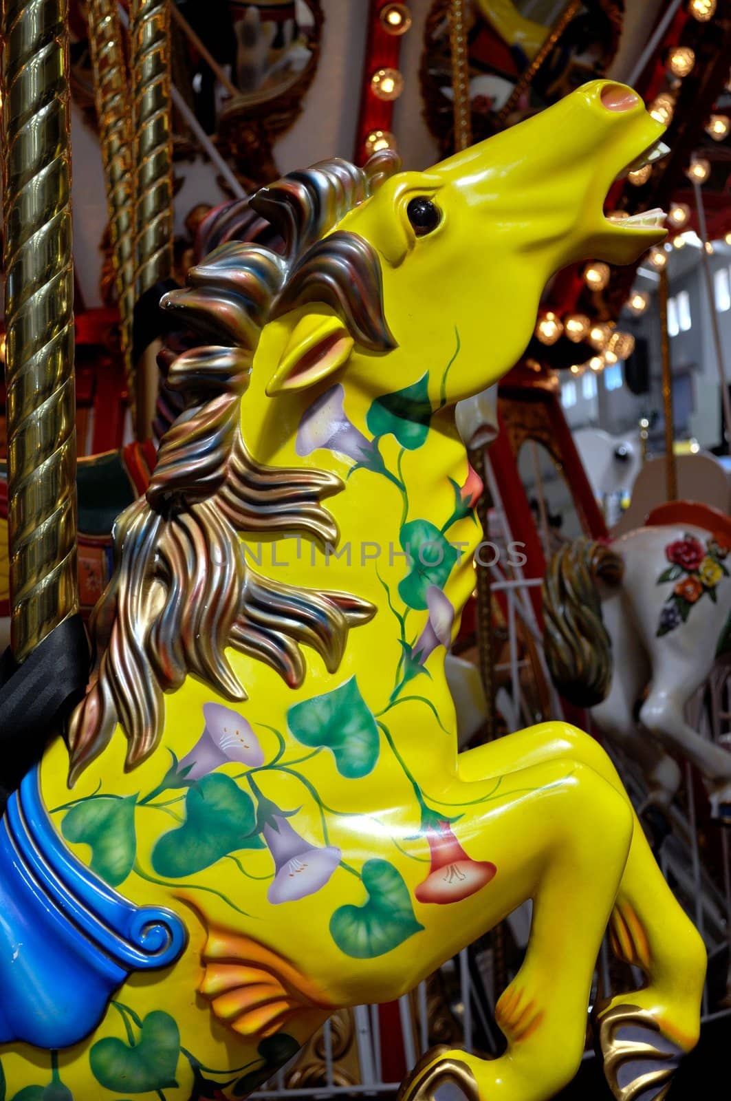 Colorful merry go round horses at the amusement park.