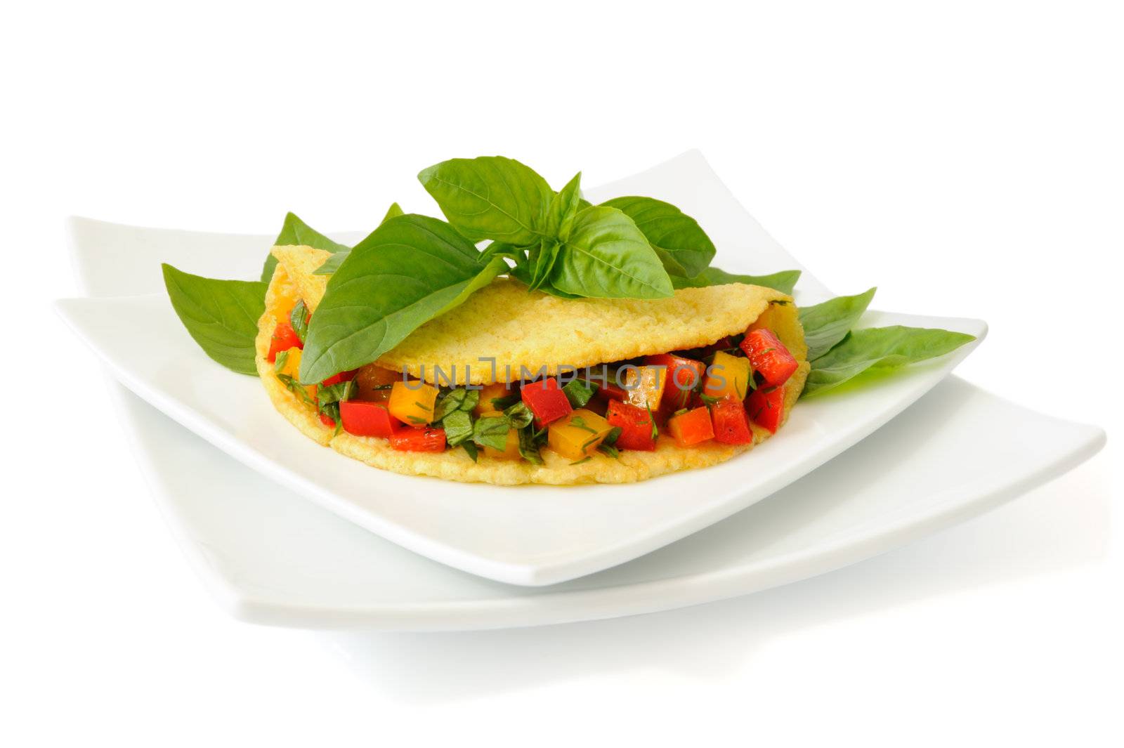 Omelet stuffed with vegetables with basil isolated