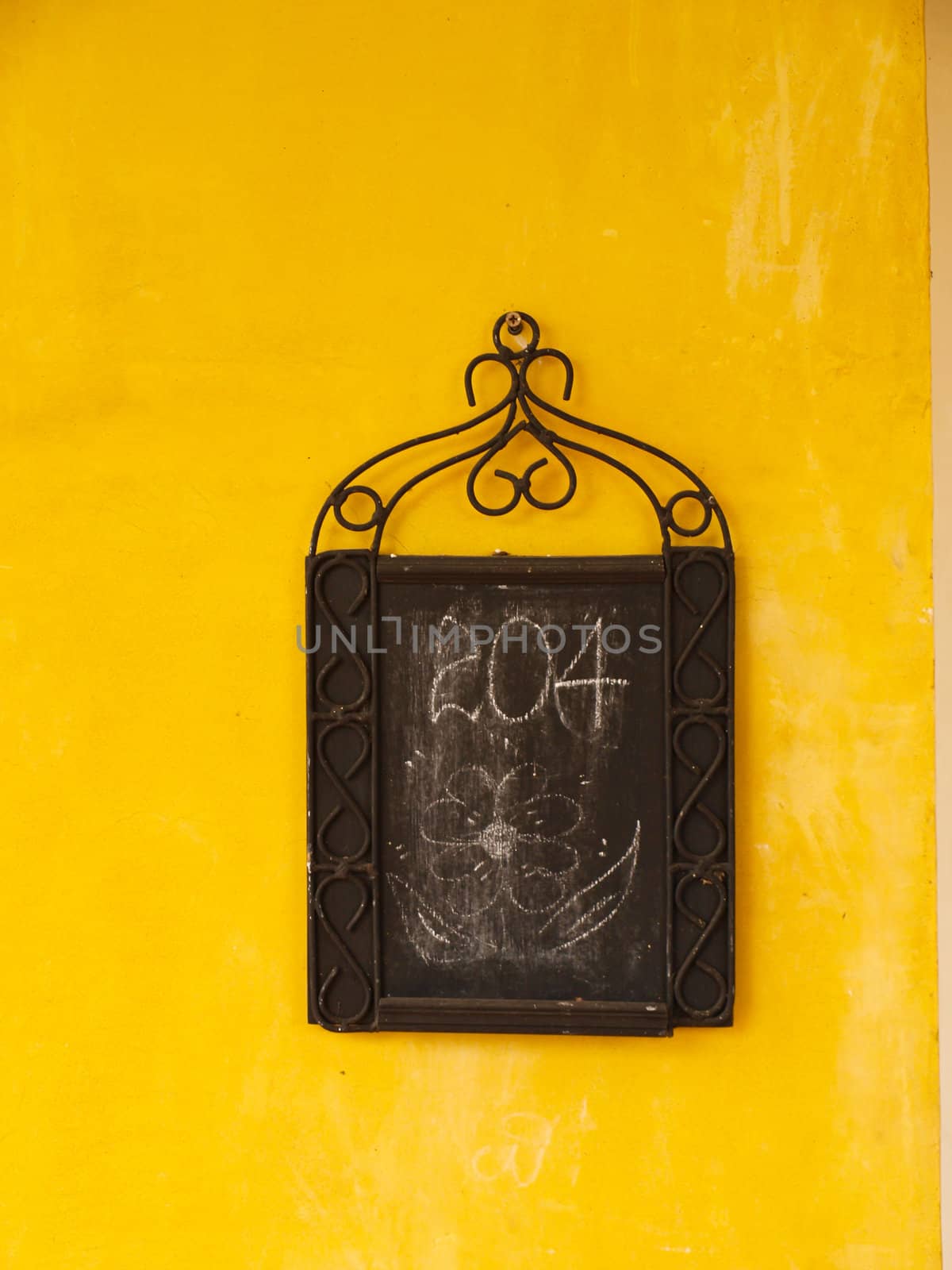 Blank board on yellow wall