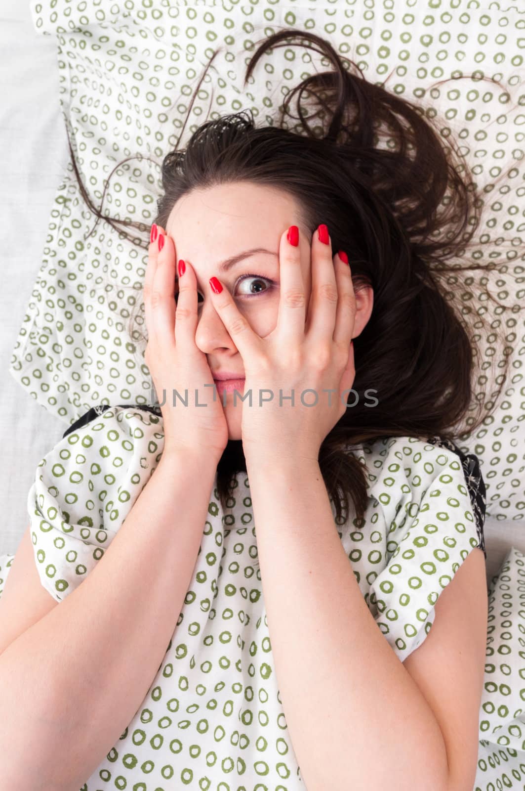 Young woman in the bed in bright light