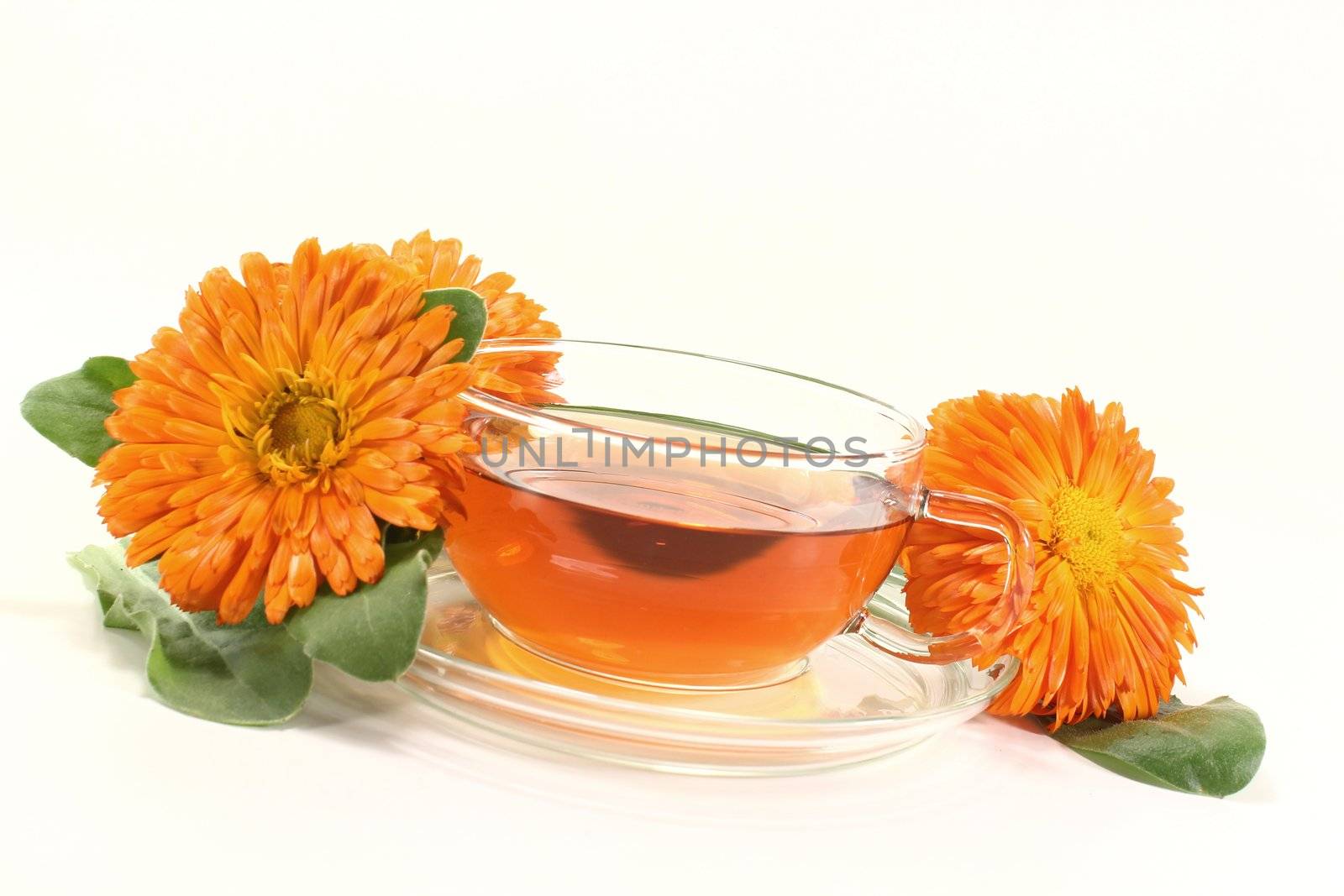 fresh marigold tea with Calendula flowers and leaves on a light background