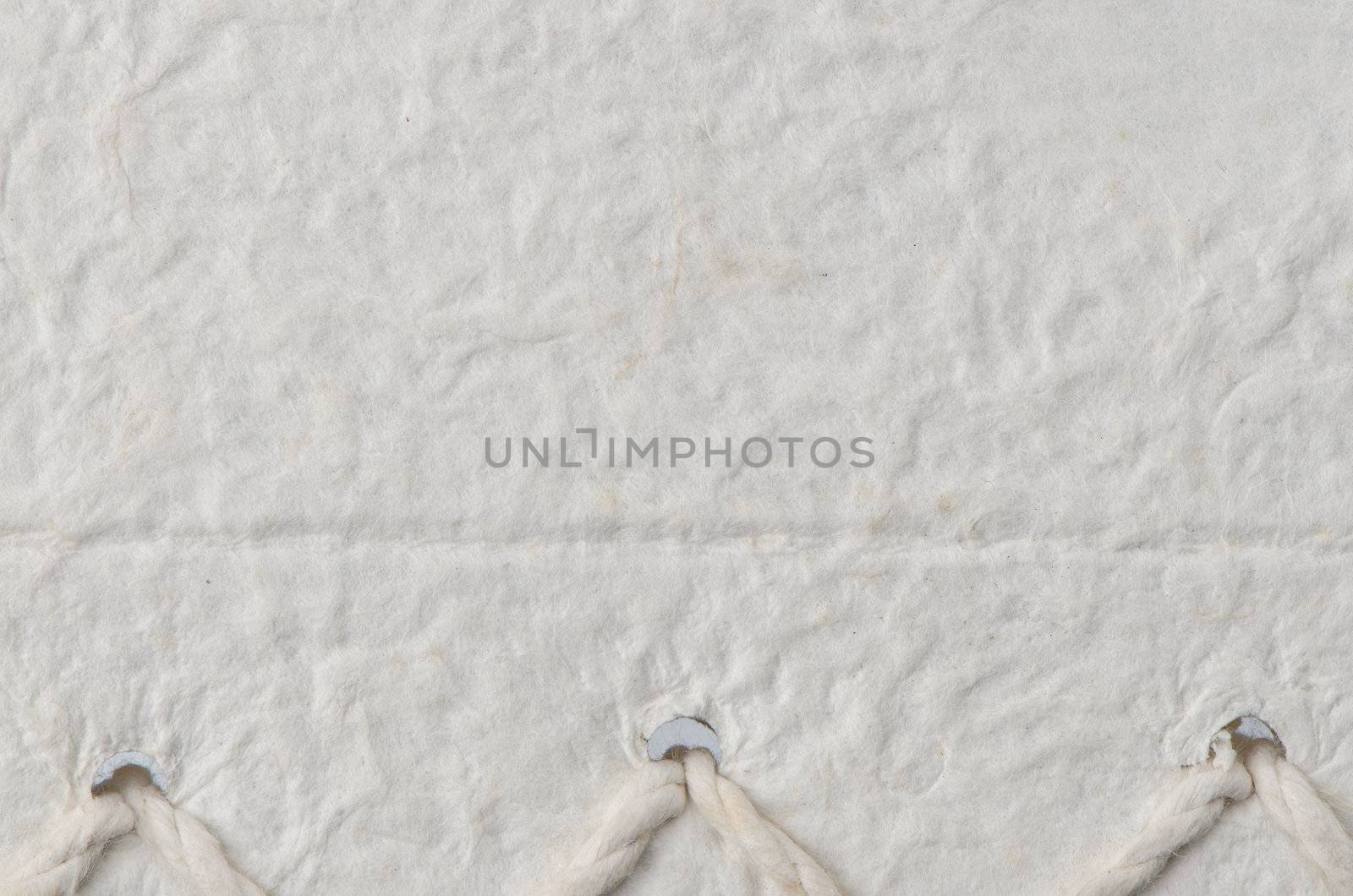 Cream textured paper closeup, can be used as a background.