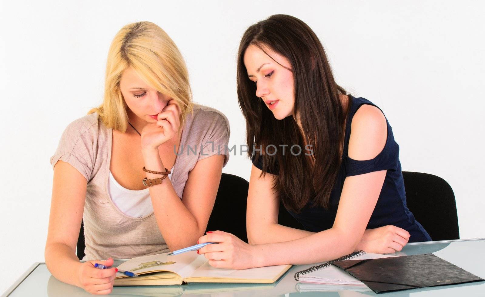 Two beautiful student girls getting ready for school isolated