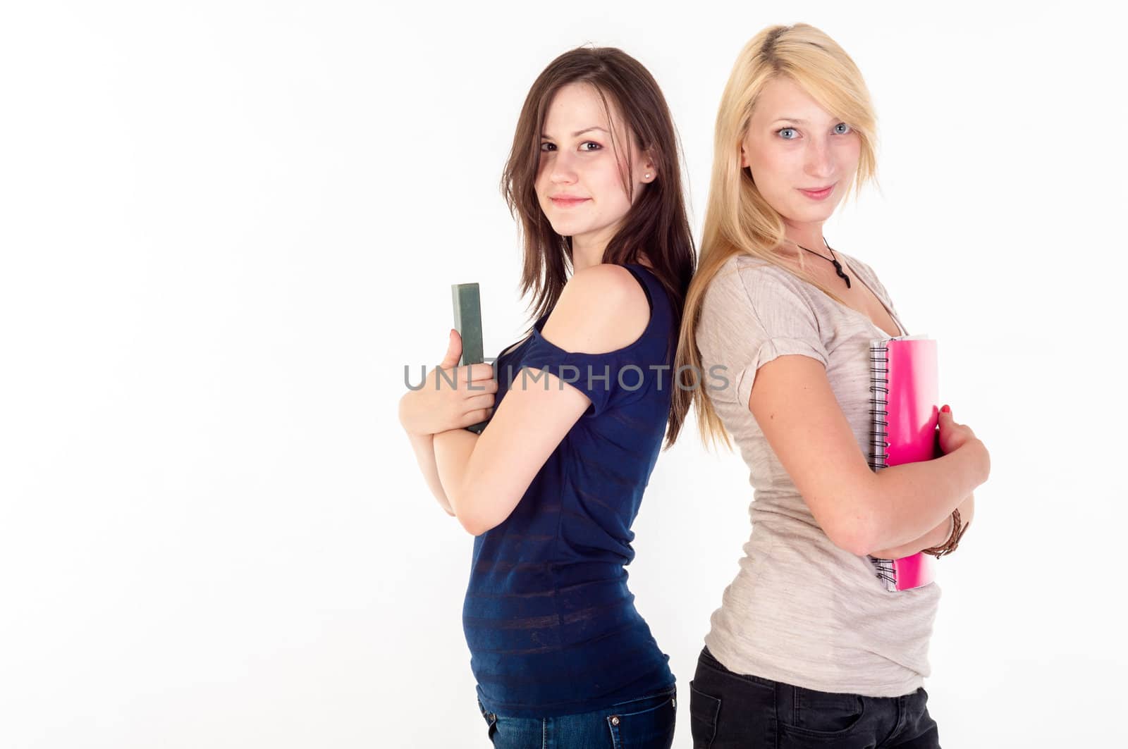 Two beautiful student girls against white background