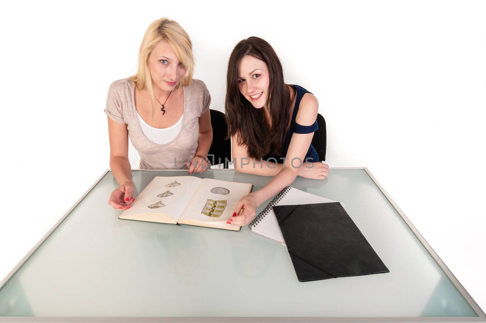 Two beautiful student girls getting ready for school isolated