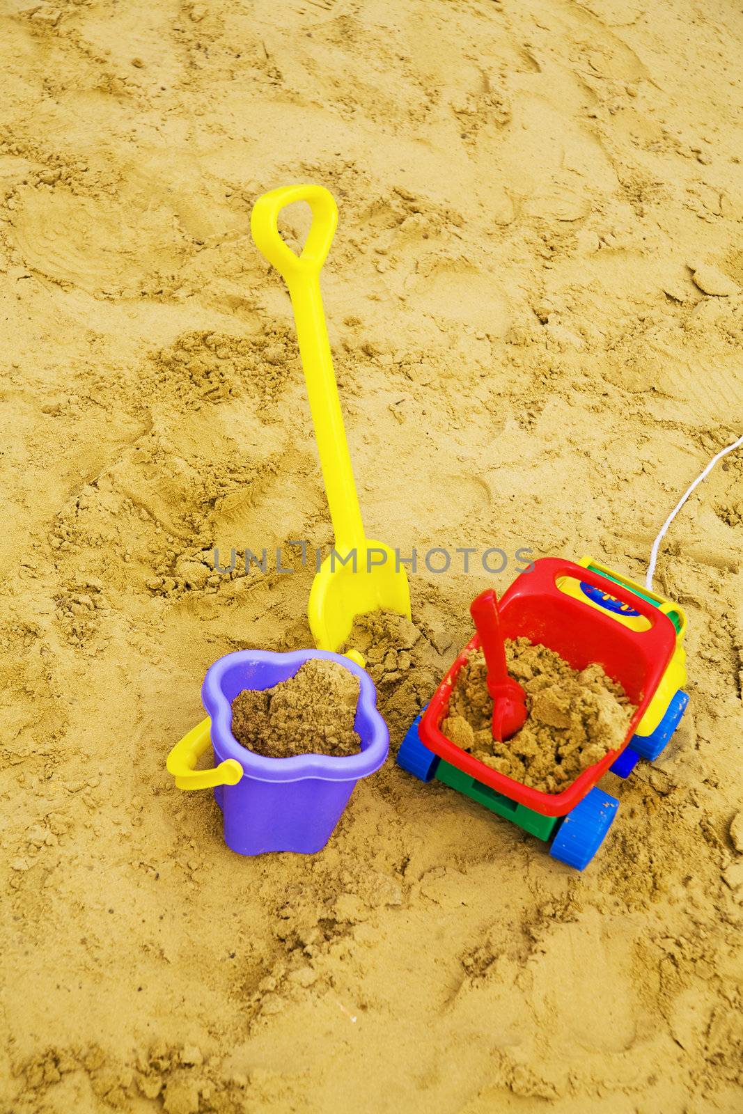 bright child's toys in sand on a playground