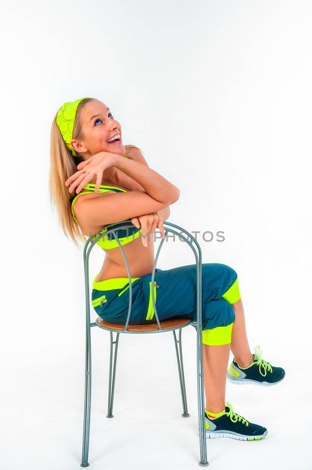 Young fitness instructor sitting on chair by svedoliver