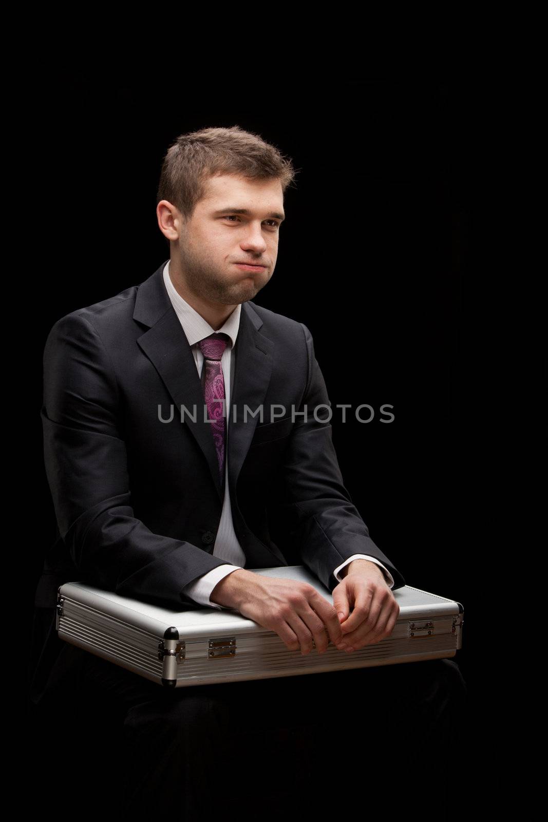 businessman with steel case over black