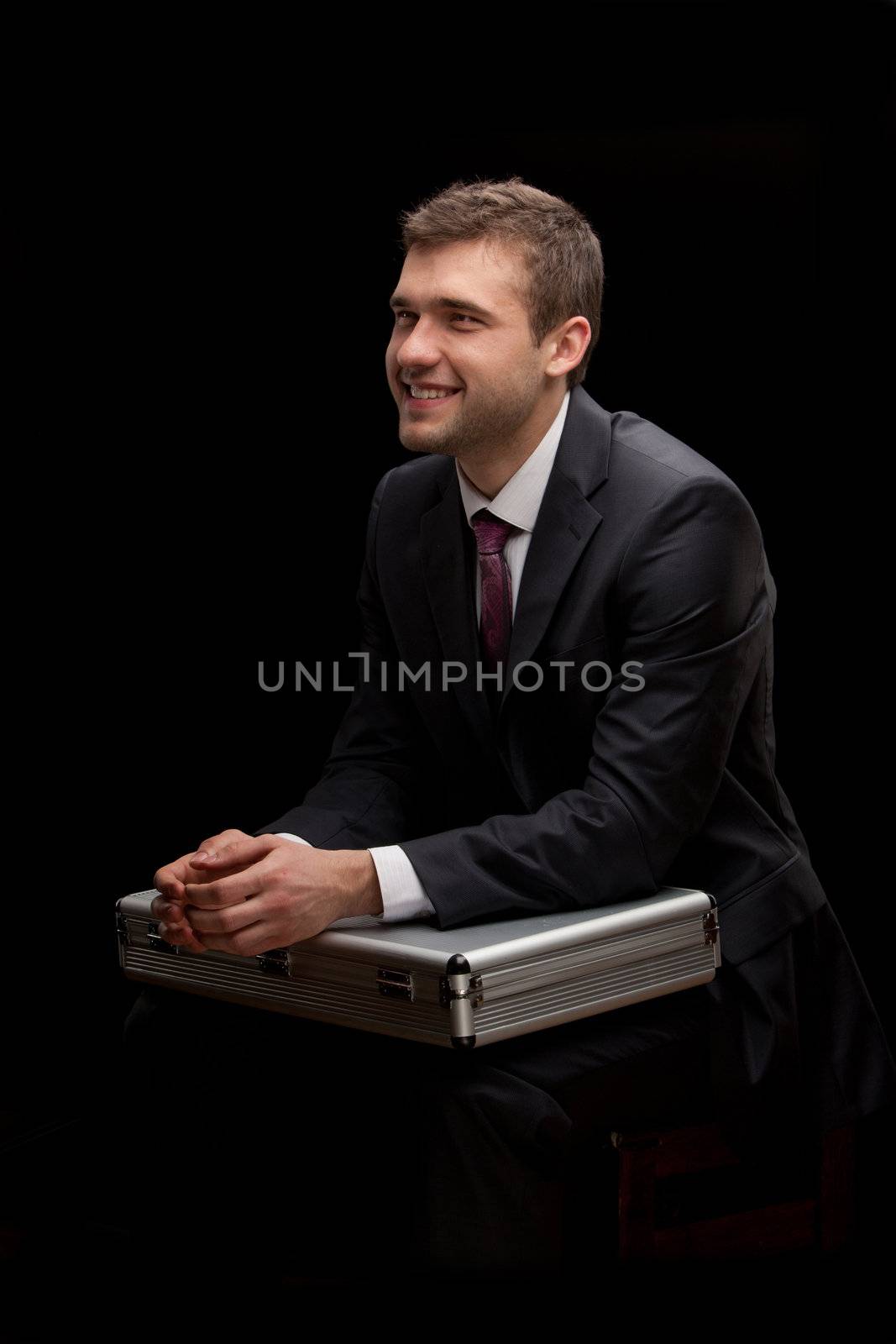 businessman with steel case over black