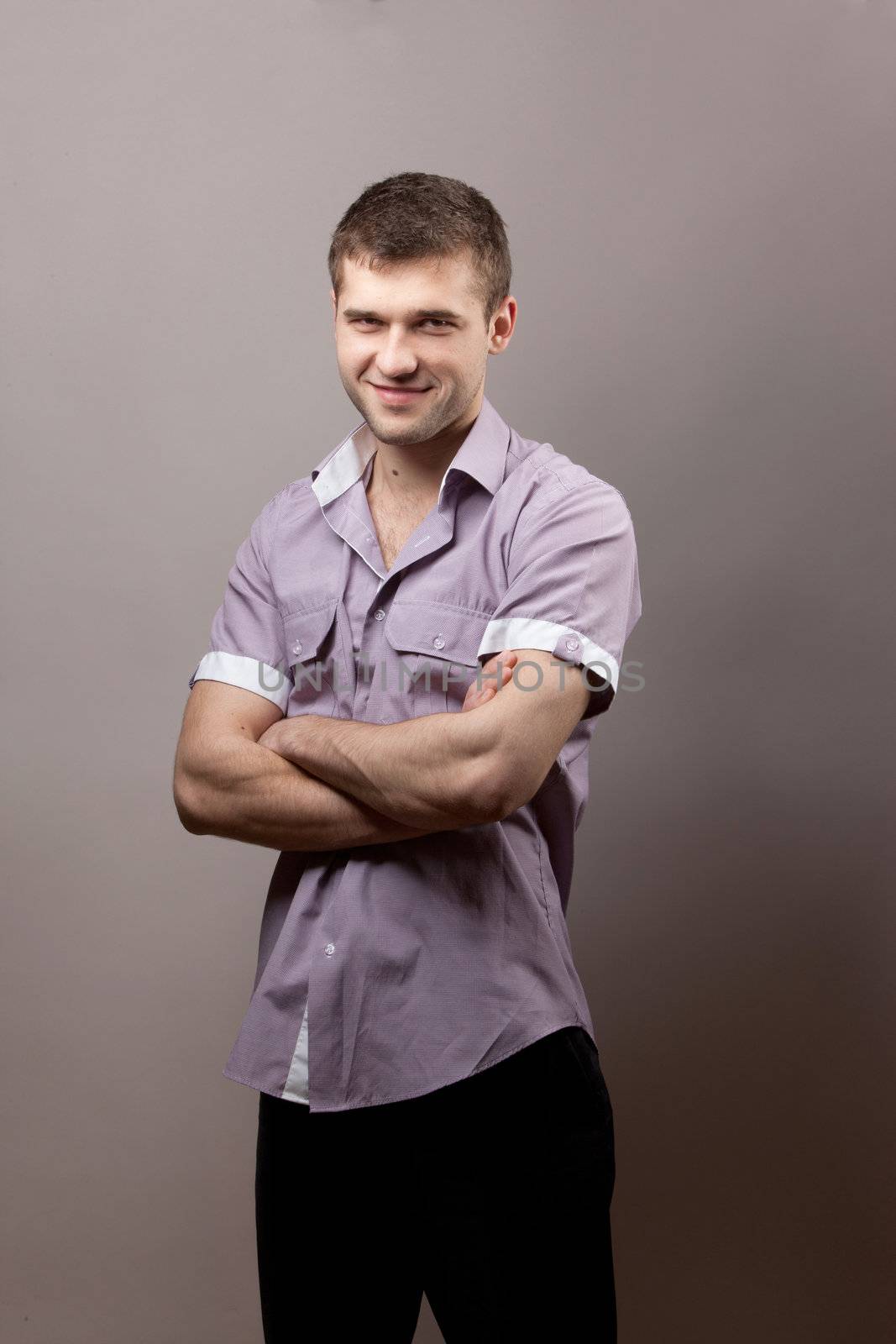 portrait of young man over gray background