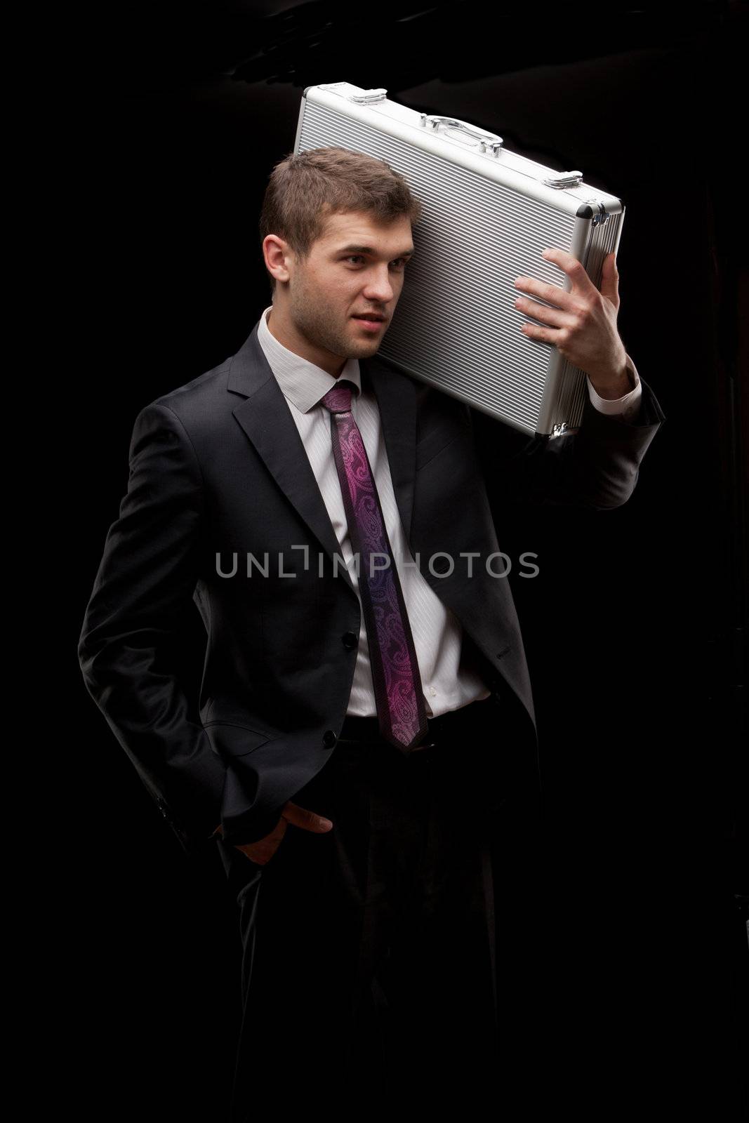 businessman with steel case over black