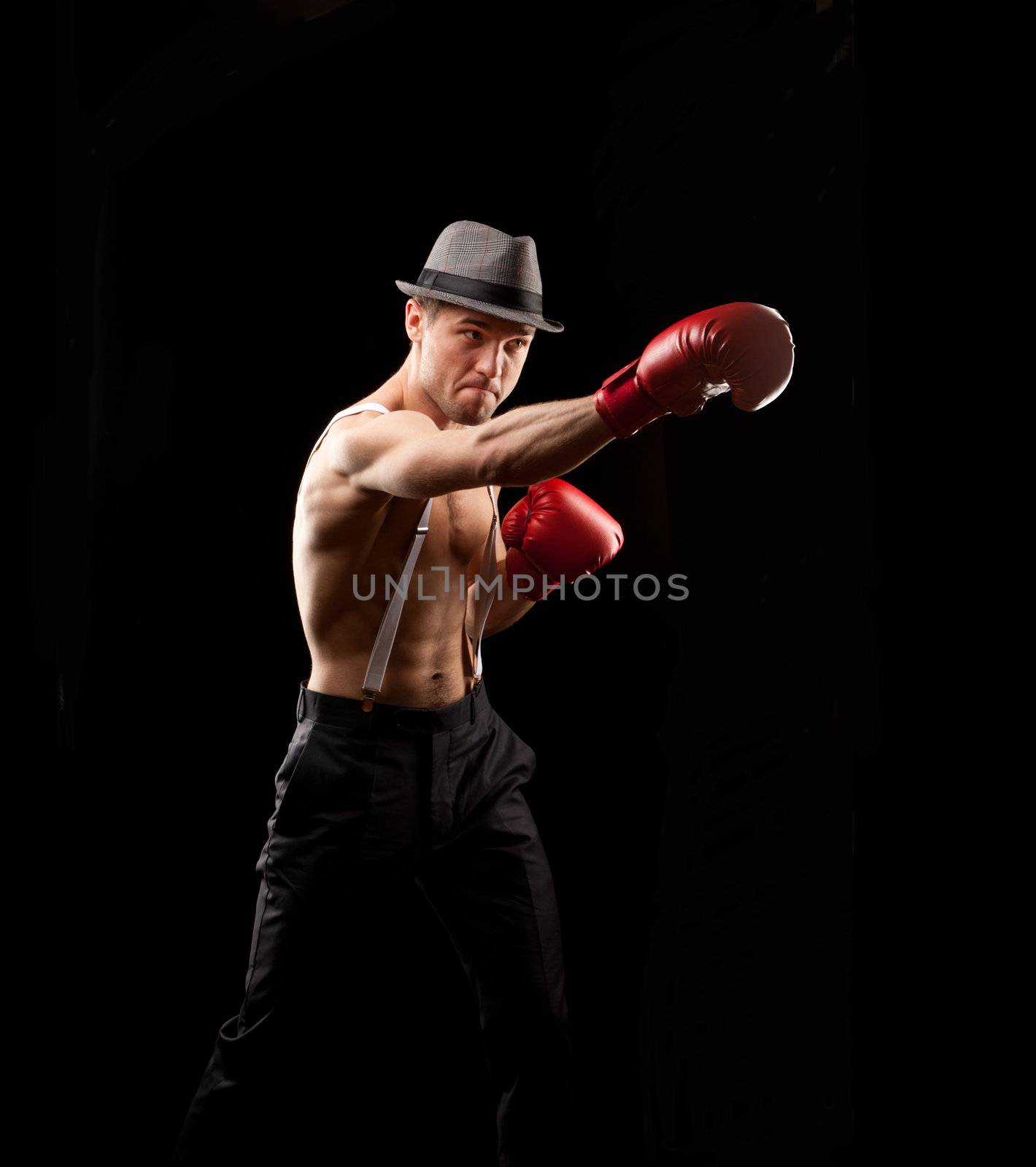 boxer in the hat on with suspenders over black