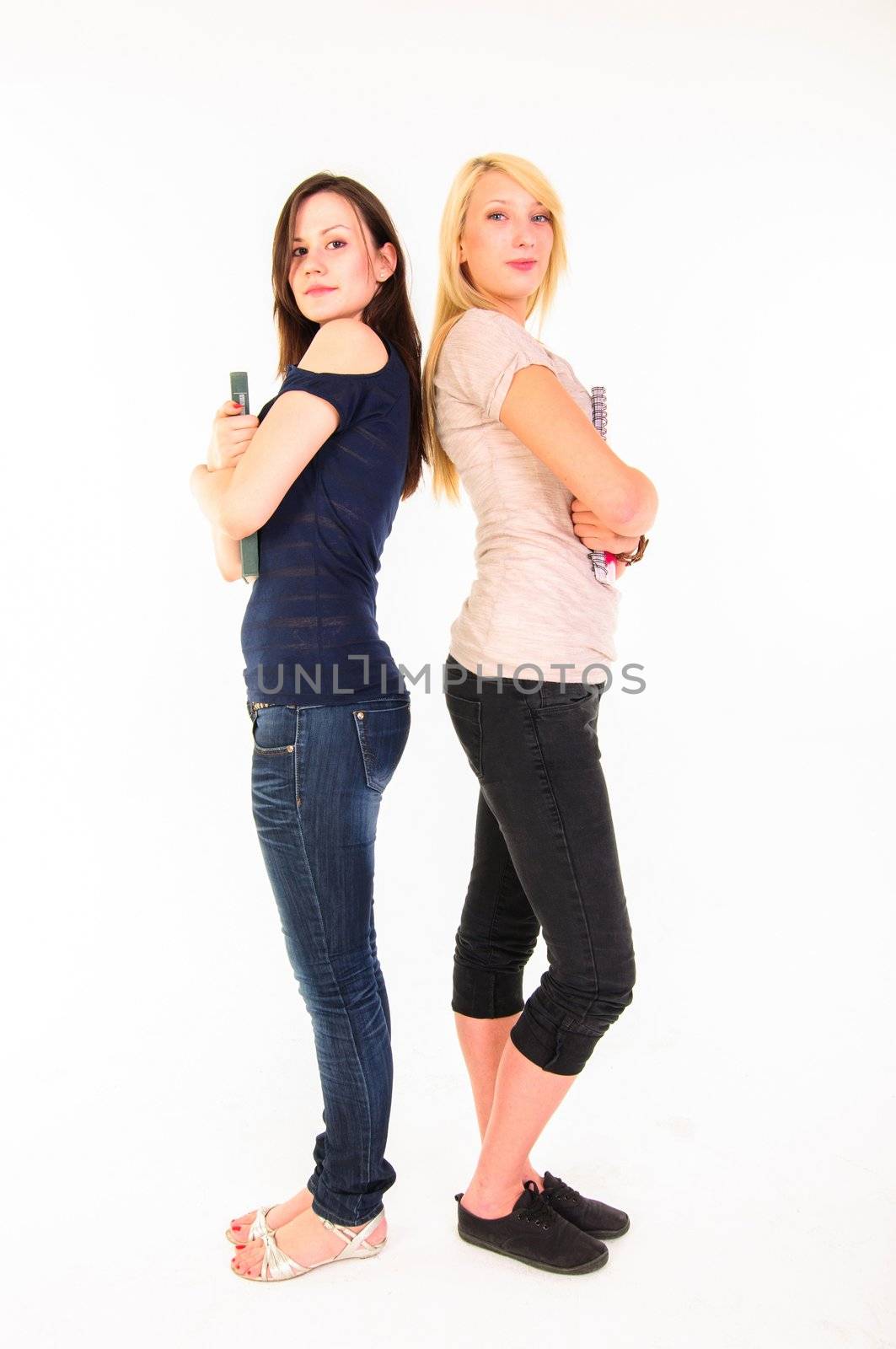 Two beautiful student girls getting ready for school isolated