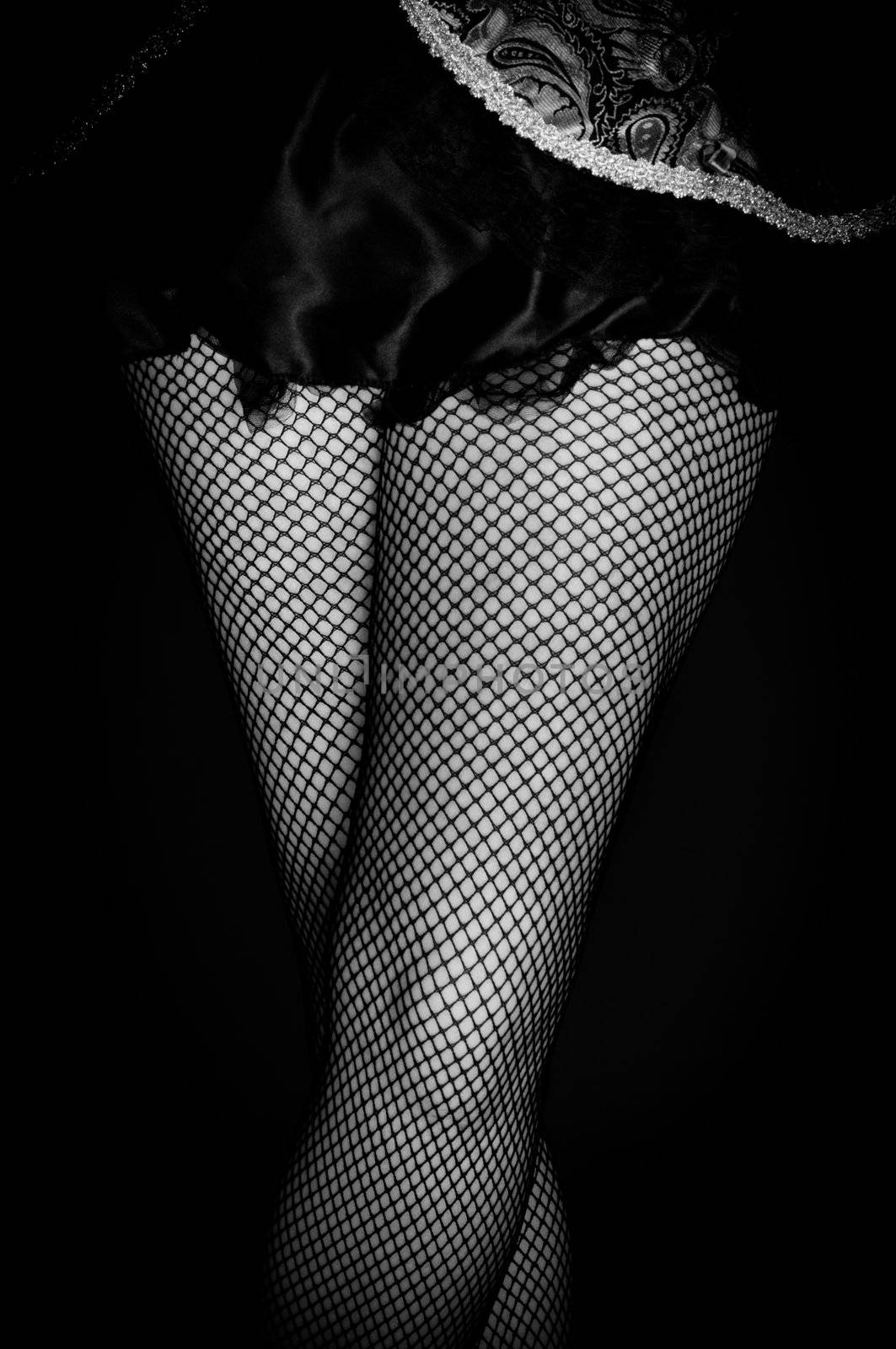Legs of a youn woman against dark background closeup