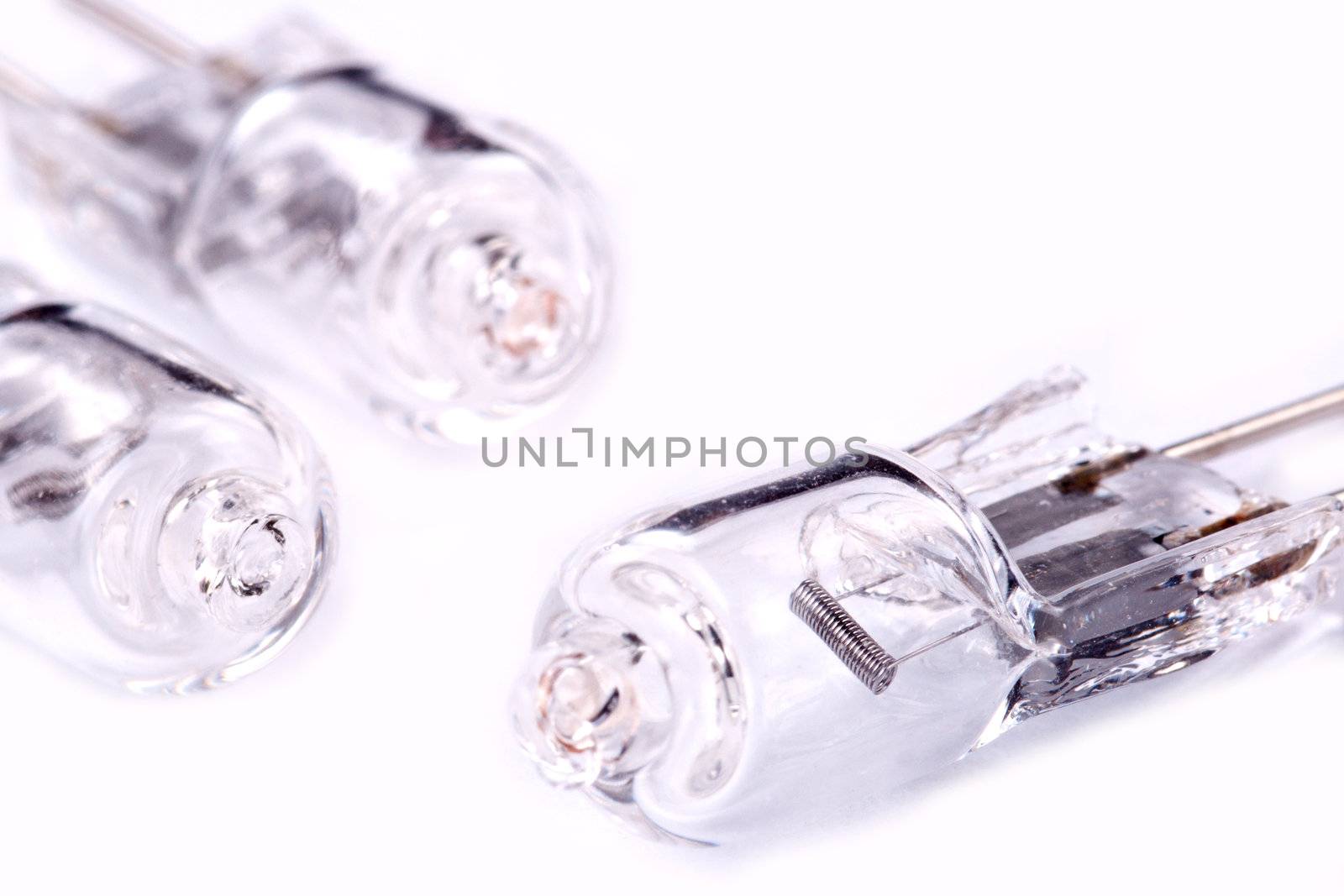 Three halogen lamps on a light grey background