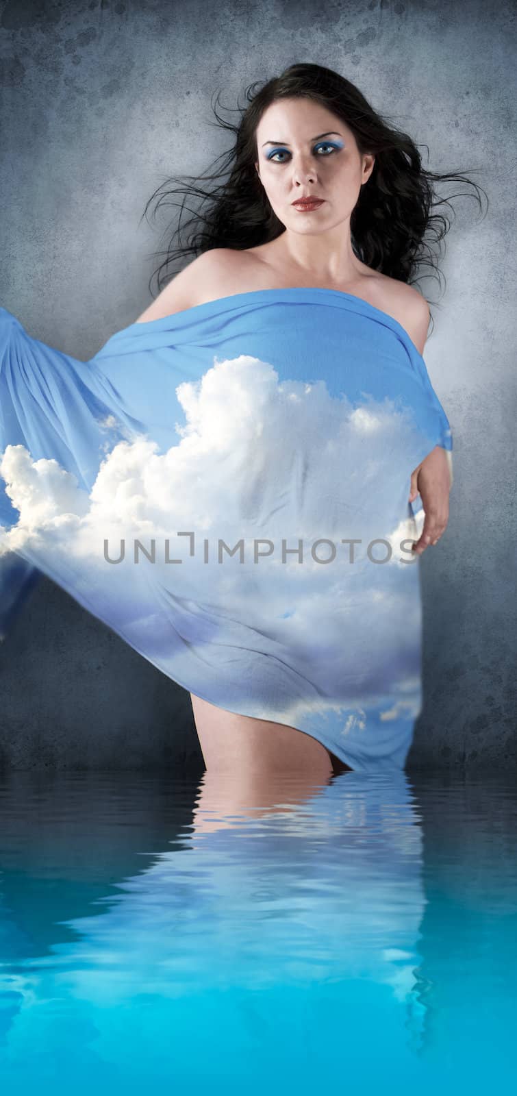Brunette woman with her head in the clouds with reflection in water