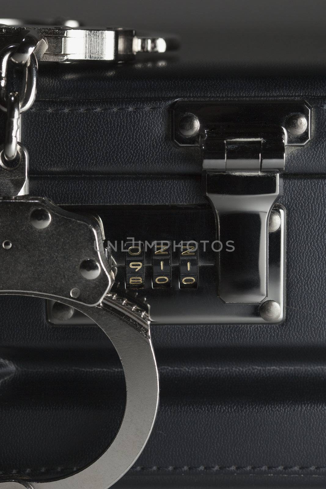 Pair of Handcuffs on Briefcase with 911 on Lock by Feverpitched