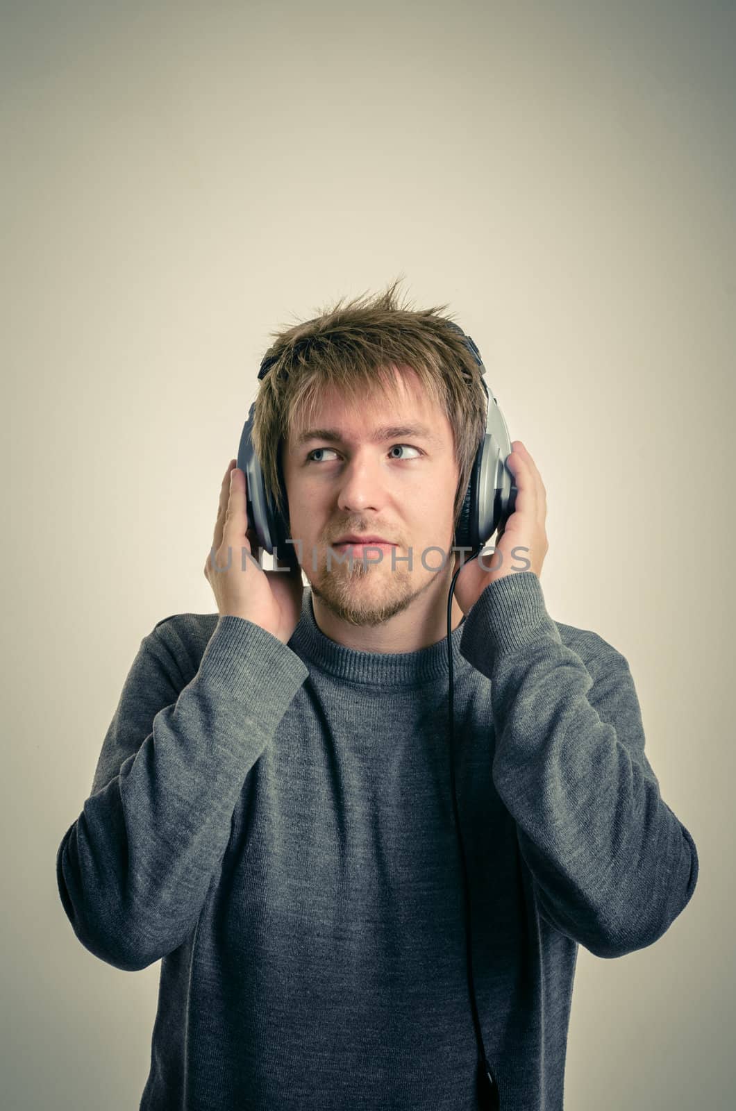 Young man with headphones against white background