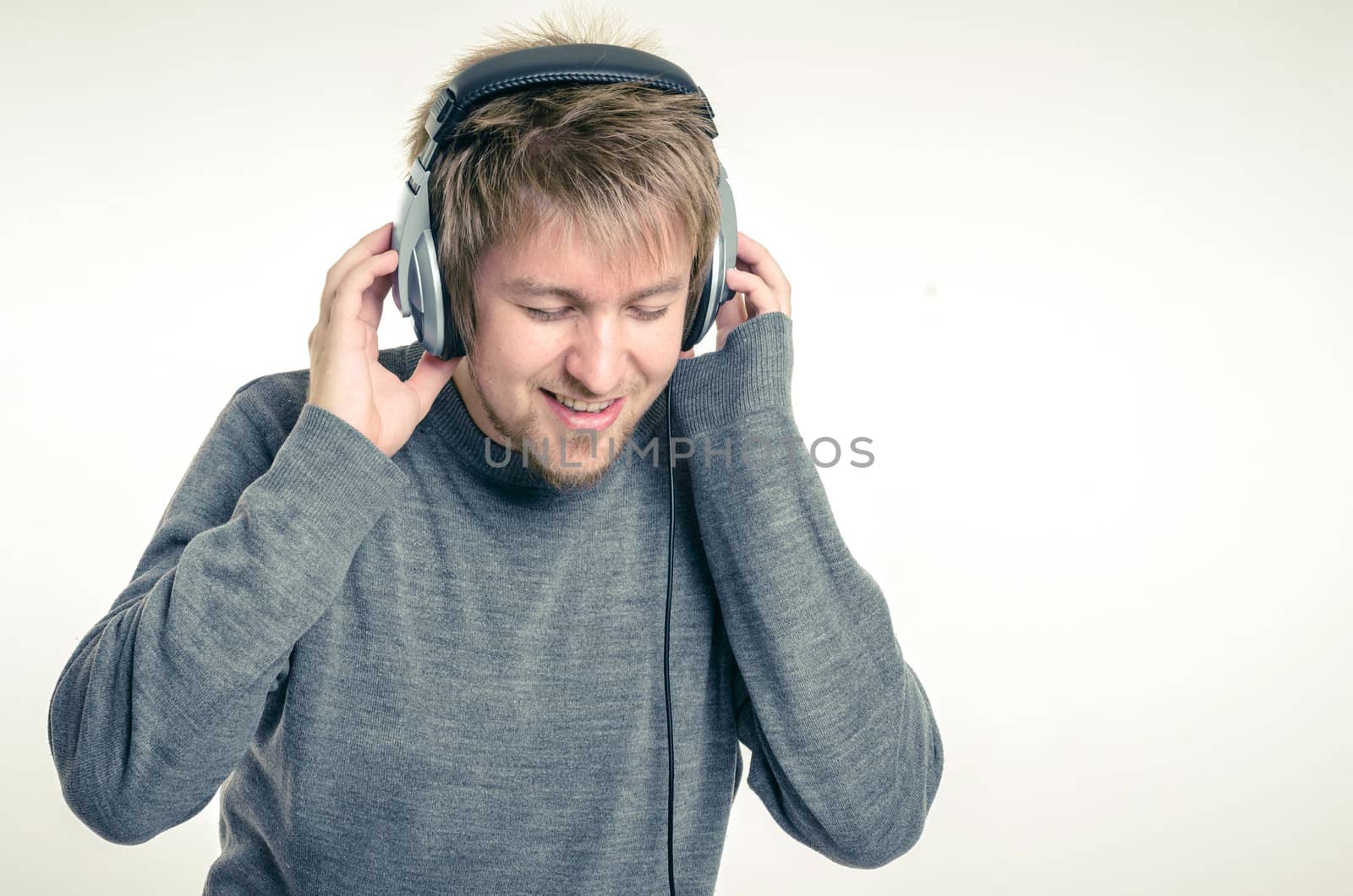 Young man with headphones against white background