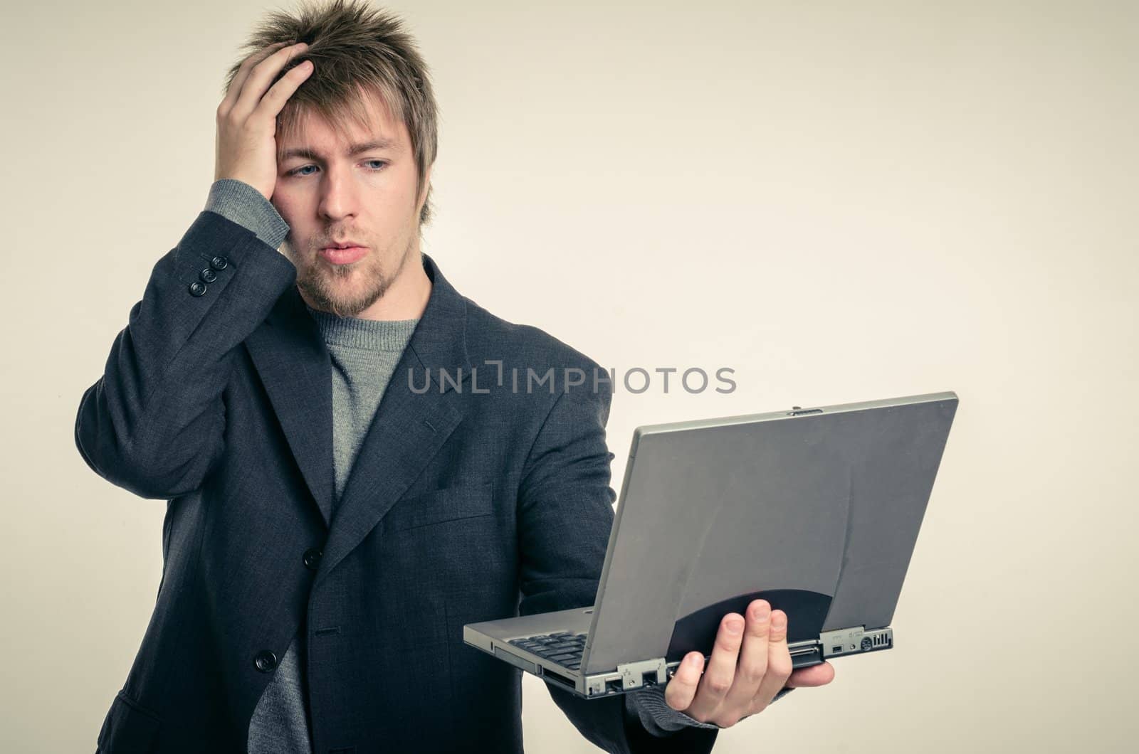 Young man in business suit against white background