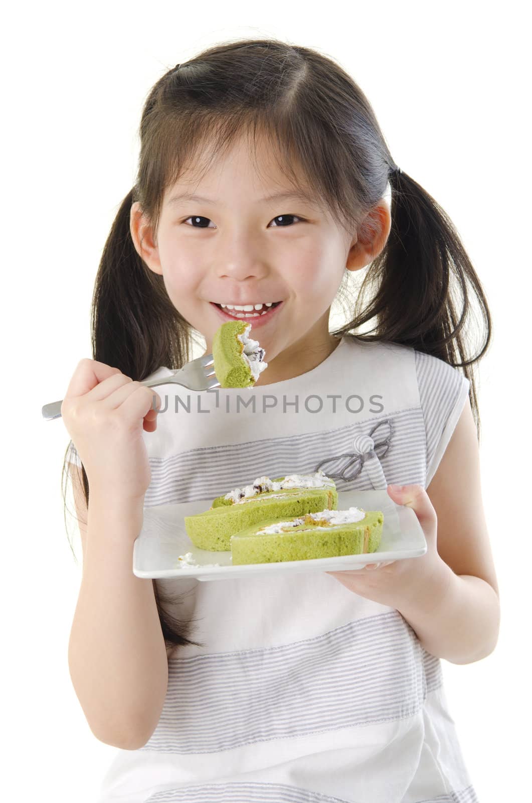 Little Asian girl is enjoying her dessert