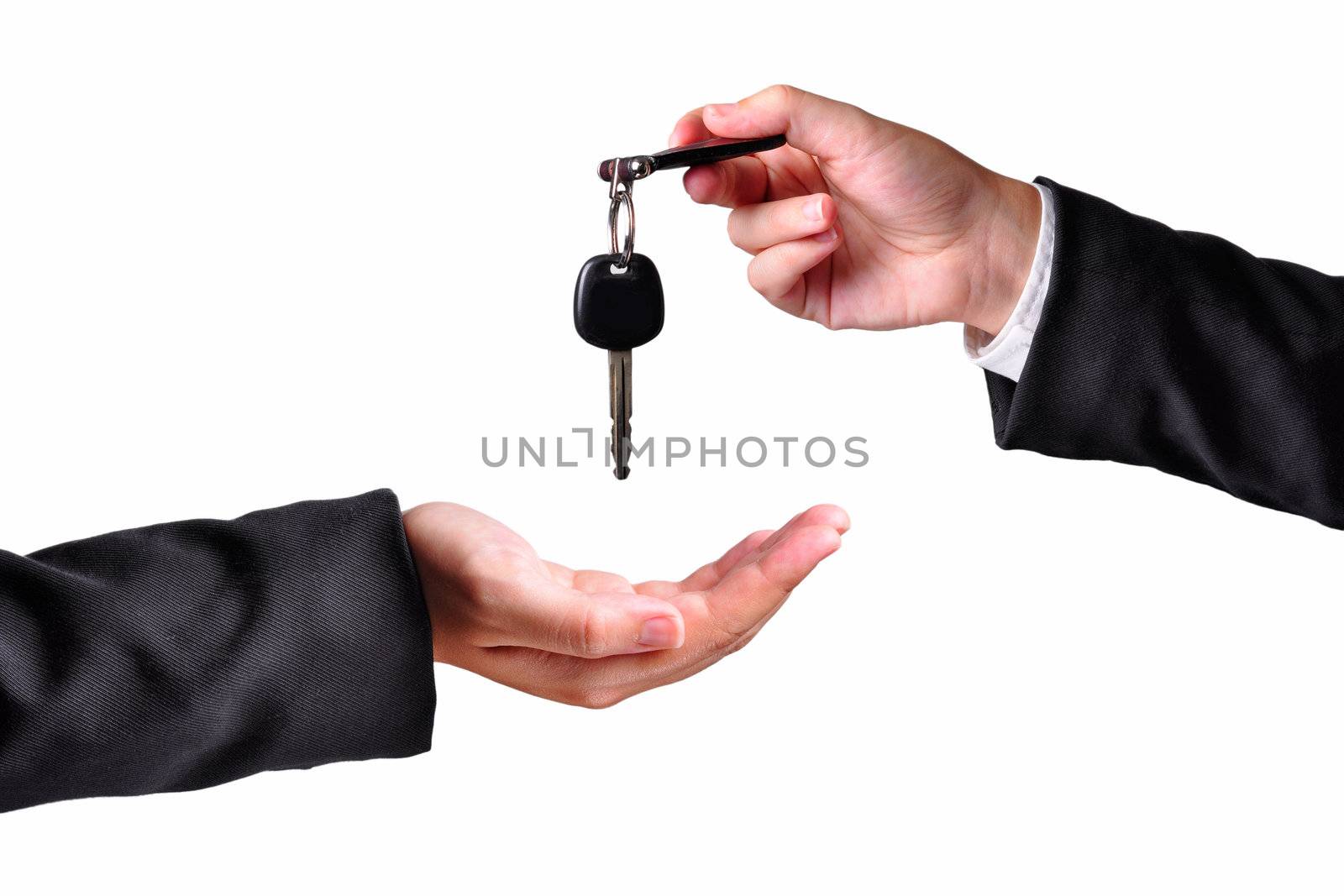 A hand giving a key to another hand. Both persons in suits. Isolated.