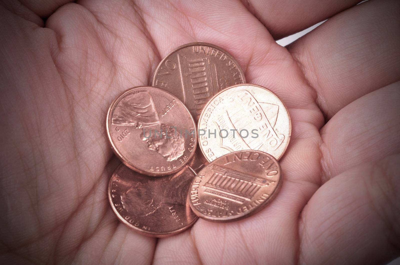 Hand holds some coins. Concept of poverty.