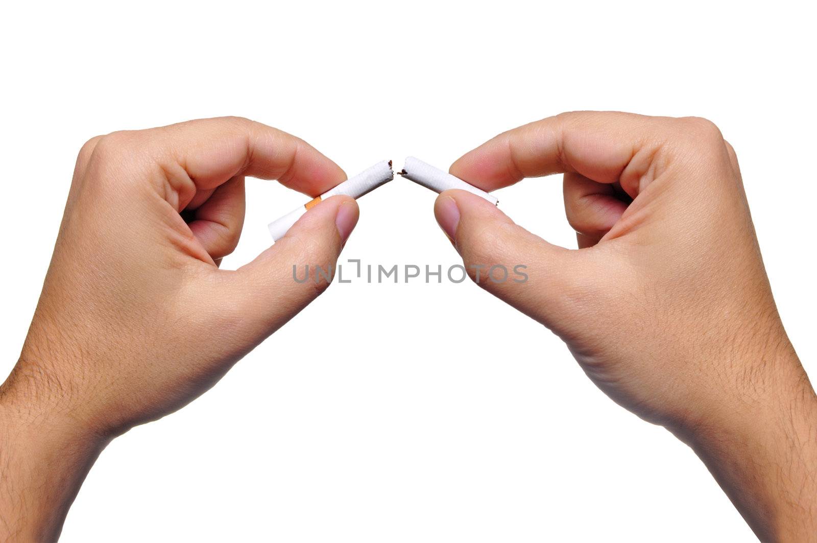 Two hands break a cigarette in half