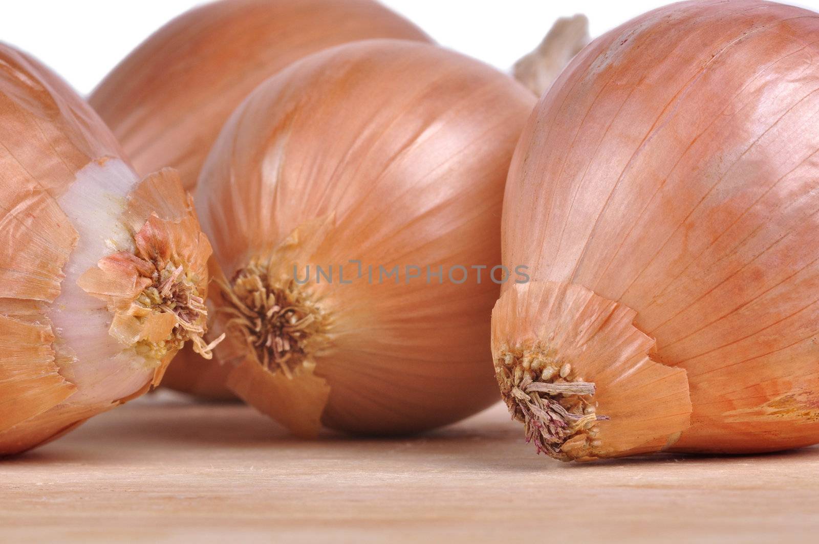 Group of onions on top of a wooden table