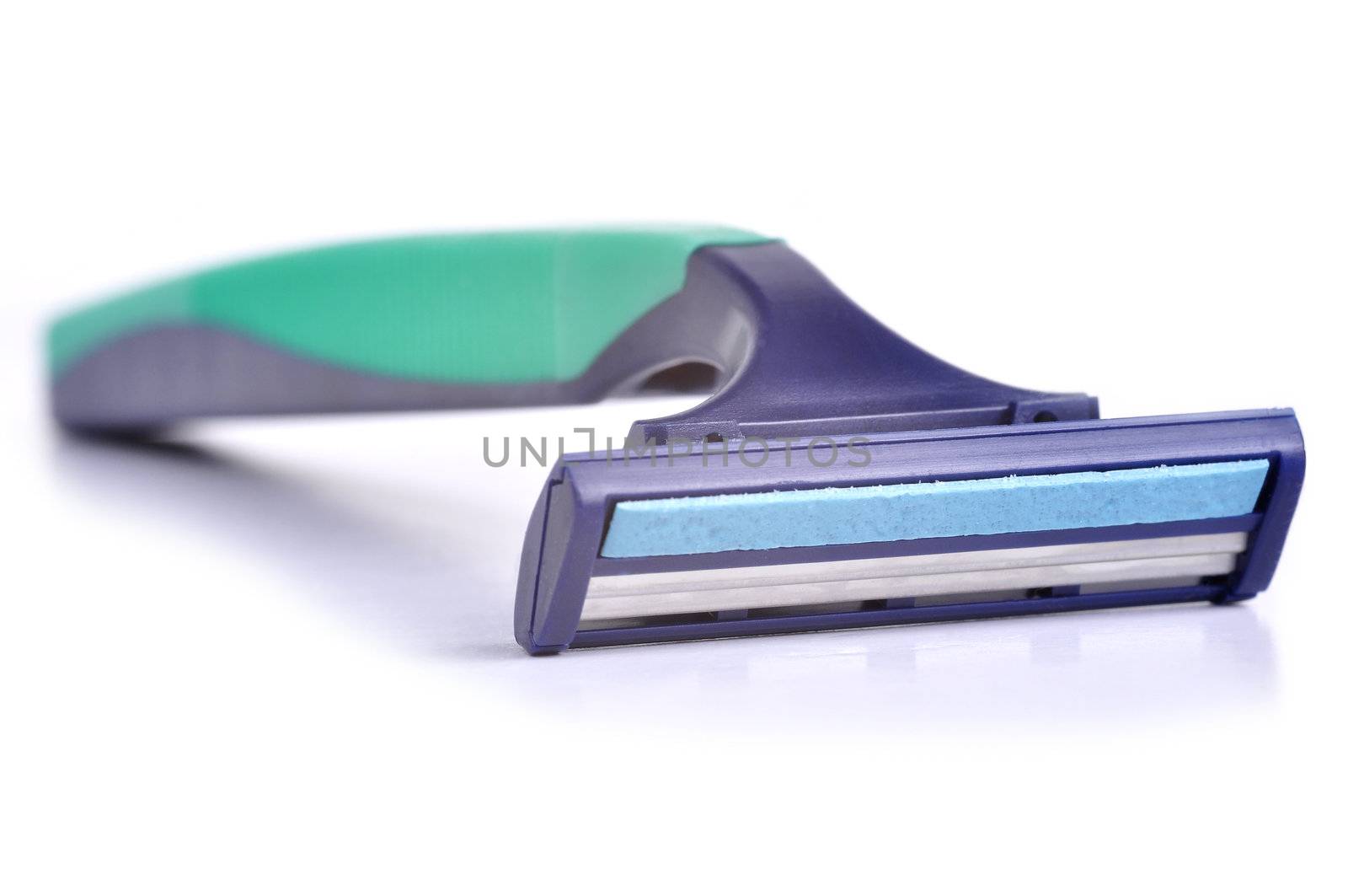Disposable razor on a white background with some reflection underneath