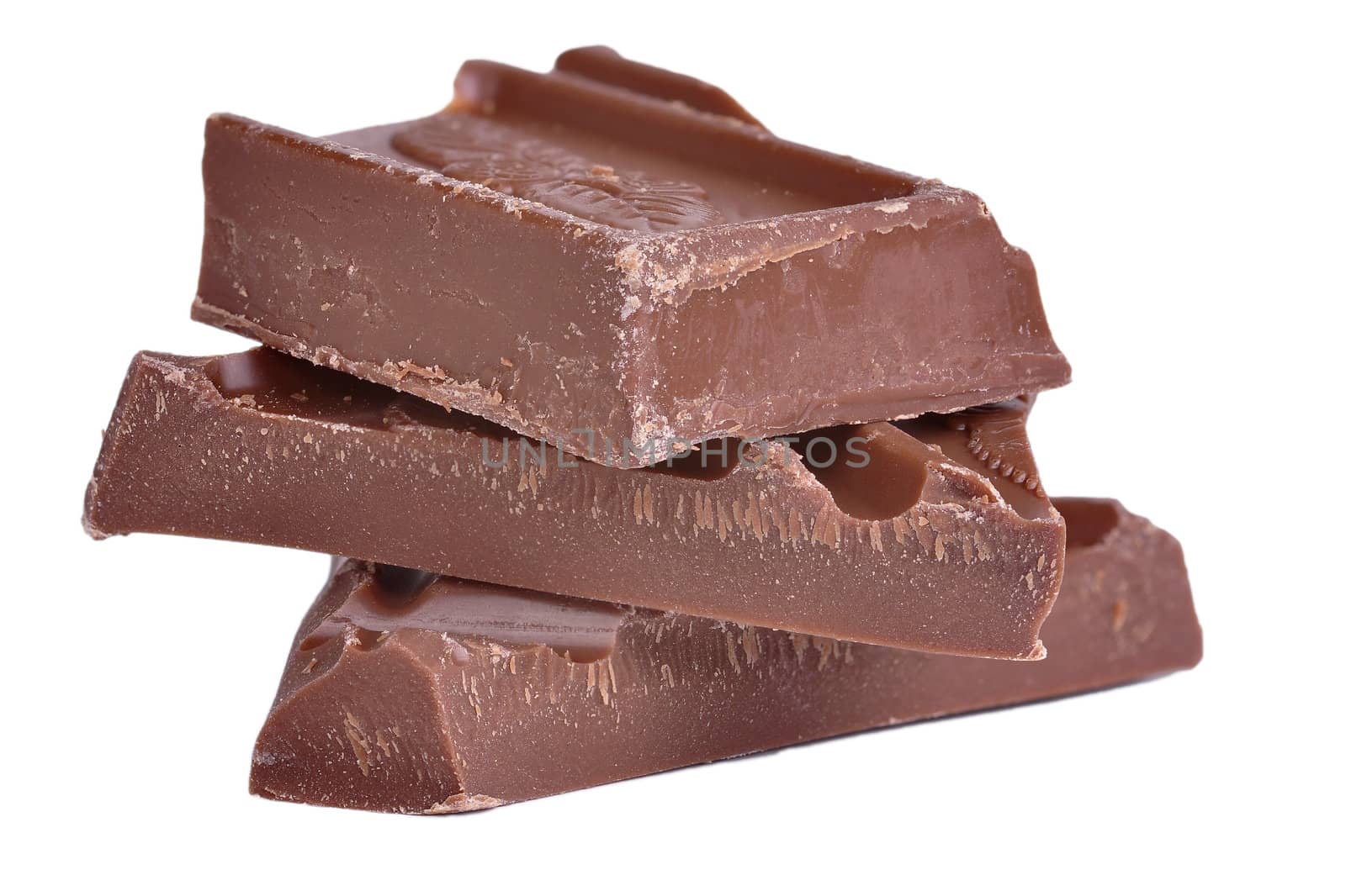 Roughly cut chunks of a chocolate bar isolated in white