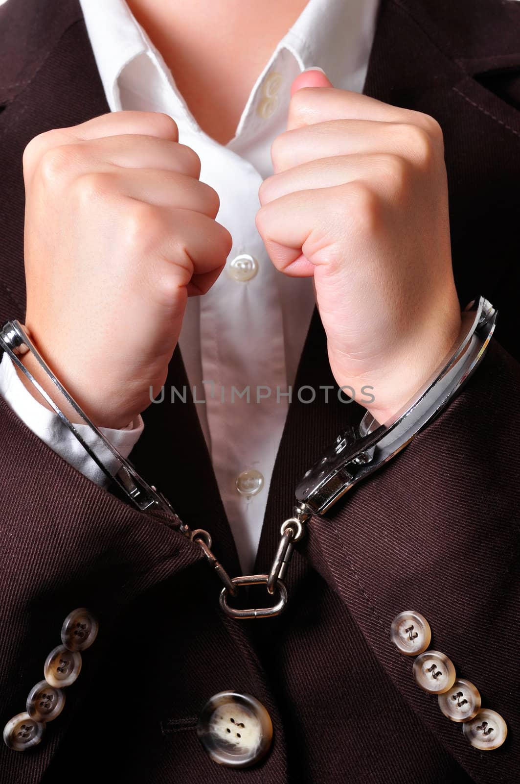 Closeup of an handcuffed businessperson in a brown suit