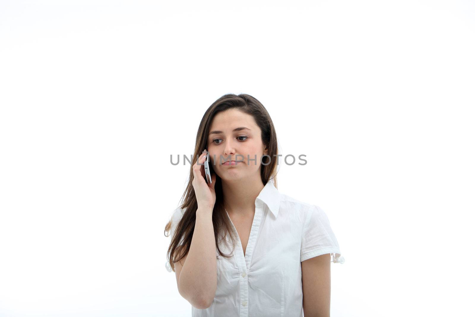 Casual woman with a serious expression listening intently to her mobile phone
