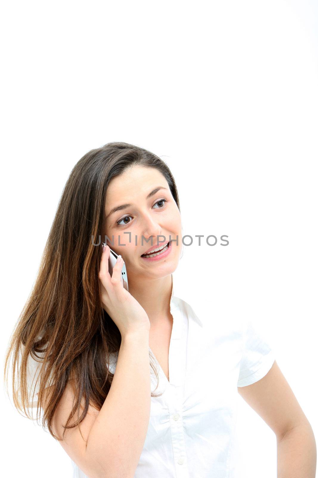 Attractive young woman with natural expression and posture talking animatedly on her mobile phone