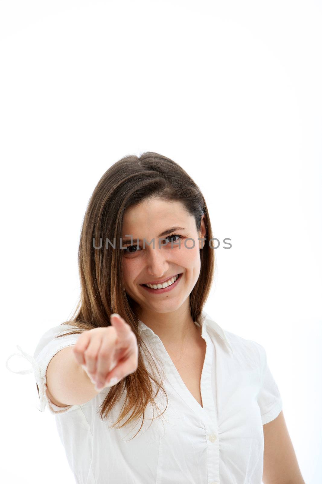 Happy smiling woman with natural expression pointing her finger directly at the camera