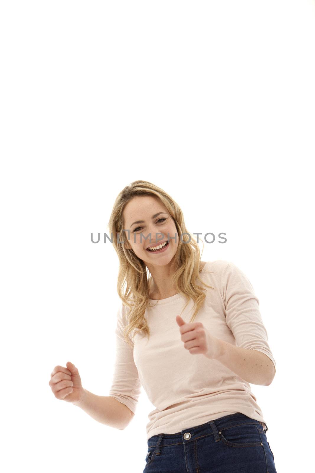Young enthusiastic blonde woman with her fists clenched in jubilation and a broad smile