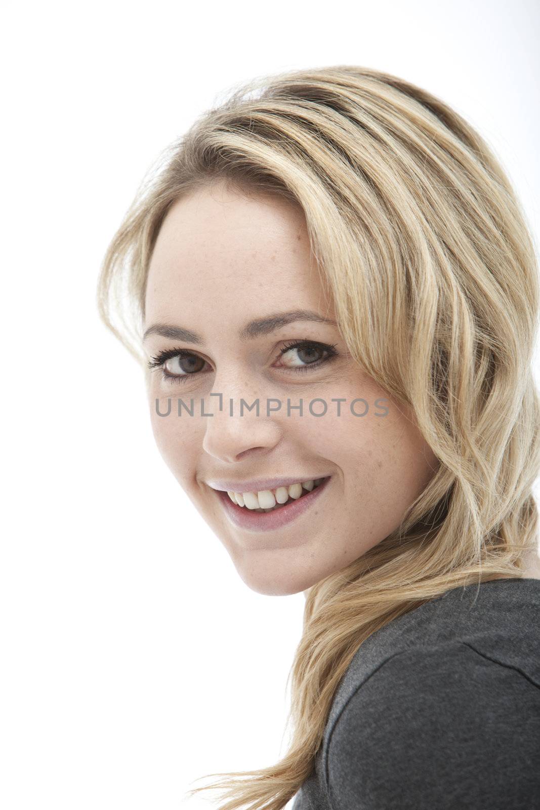 Portrait of attractive smiling blonde on white background