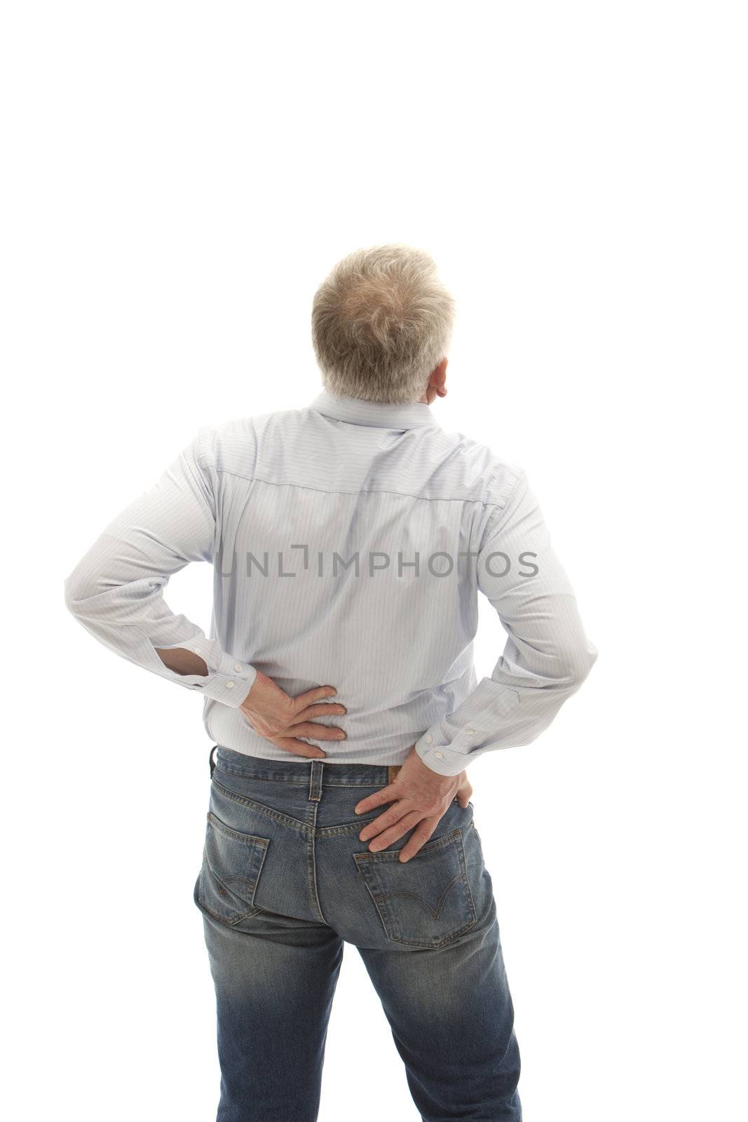 Senior man facing away from the camera holding hi slower back with both hands as though in pain