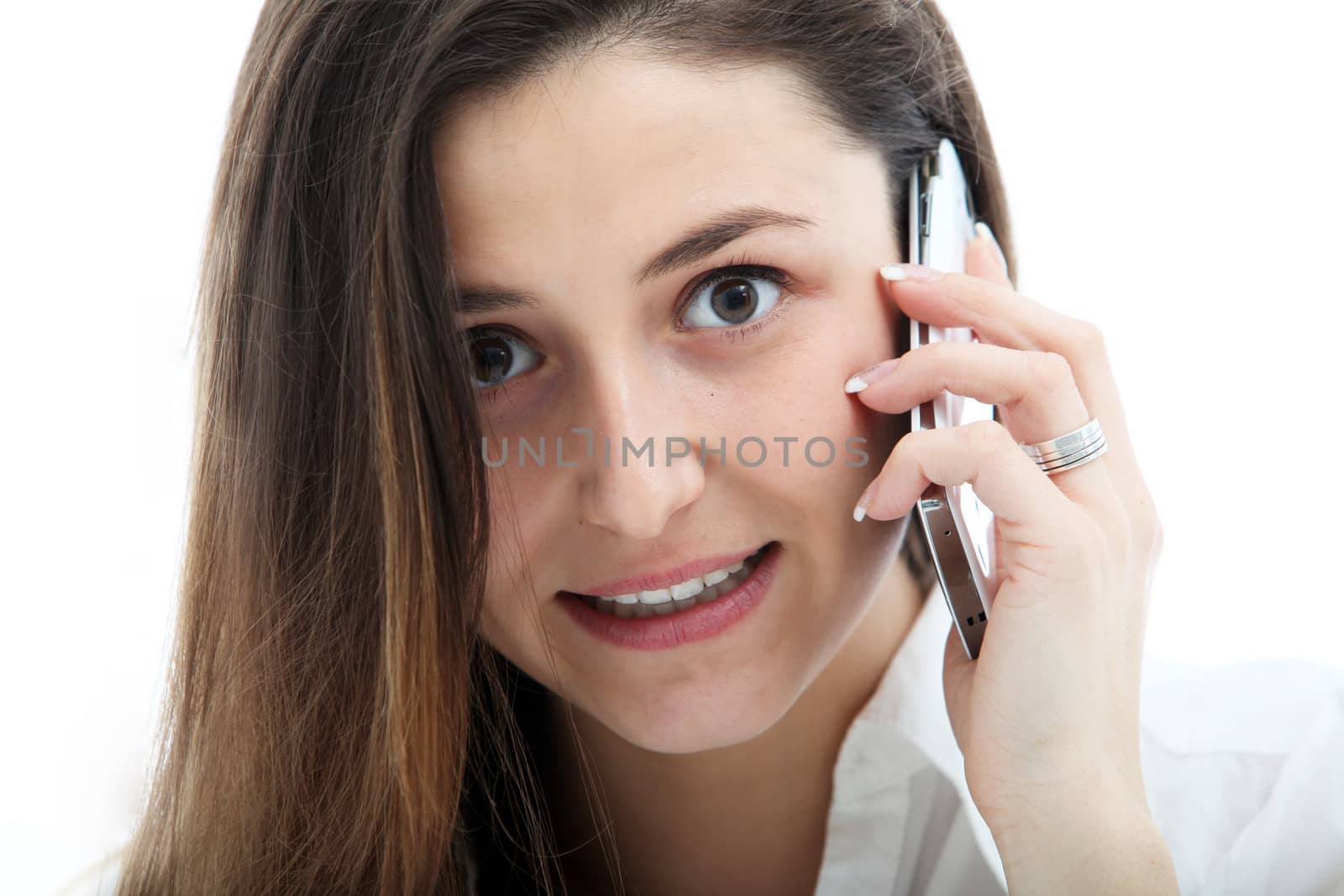 Closeup of the facial expression of an earnest young woman talking on mobile phone