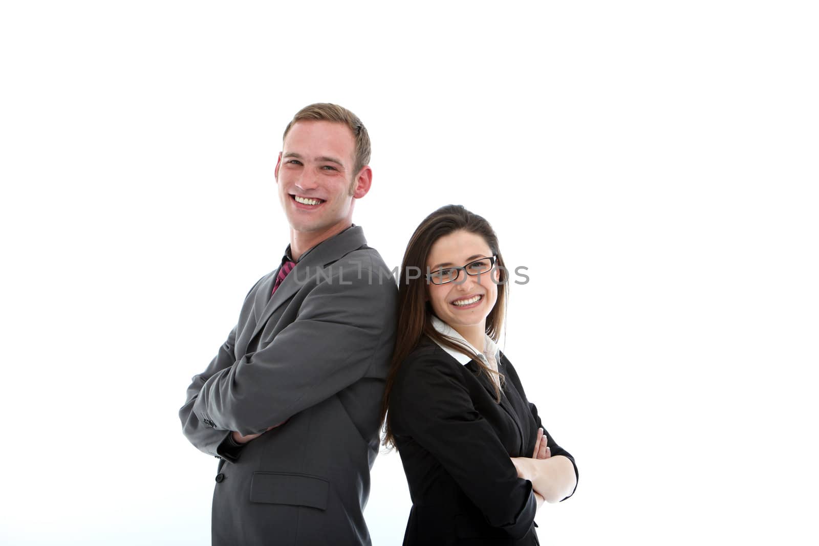 Two smiling friendly business partners stand back to back in a show of solidarity and teamwork