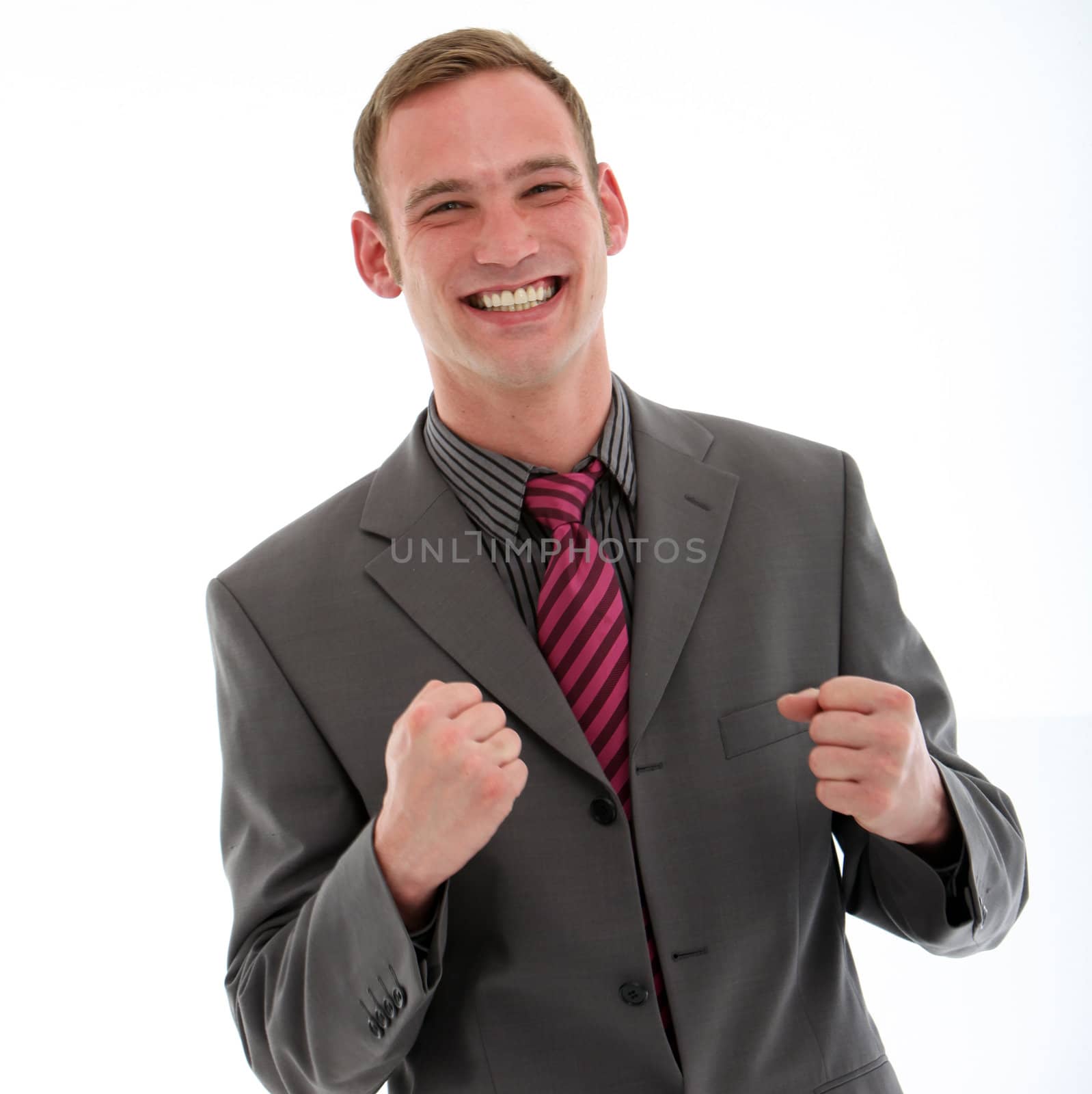 Excited businessman punching his fists in the air in jubilation at the news of his success or promotion