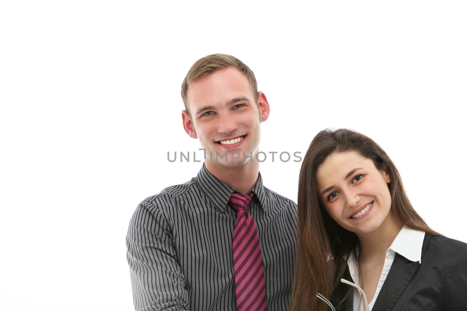 Attractive welcoming friendly young professional couple standing side by side smiling into the camera , isolated head and shoulders pose.