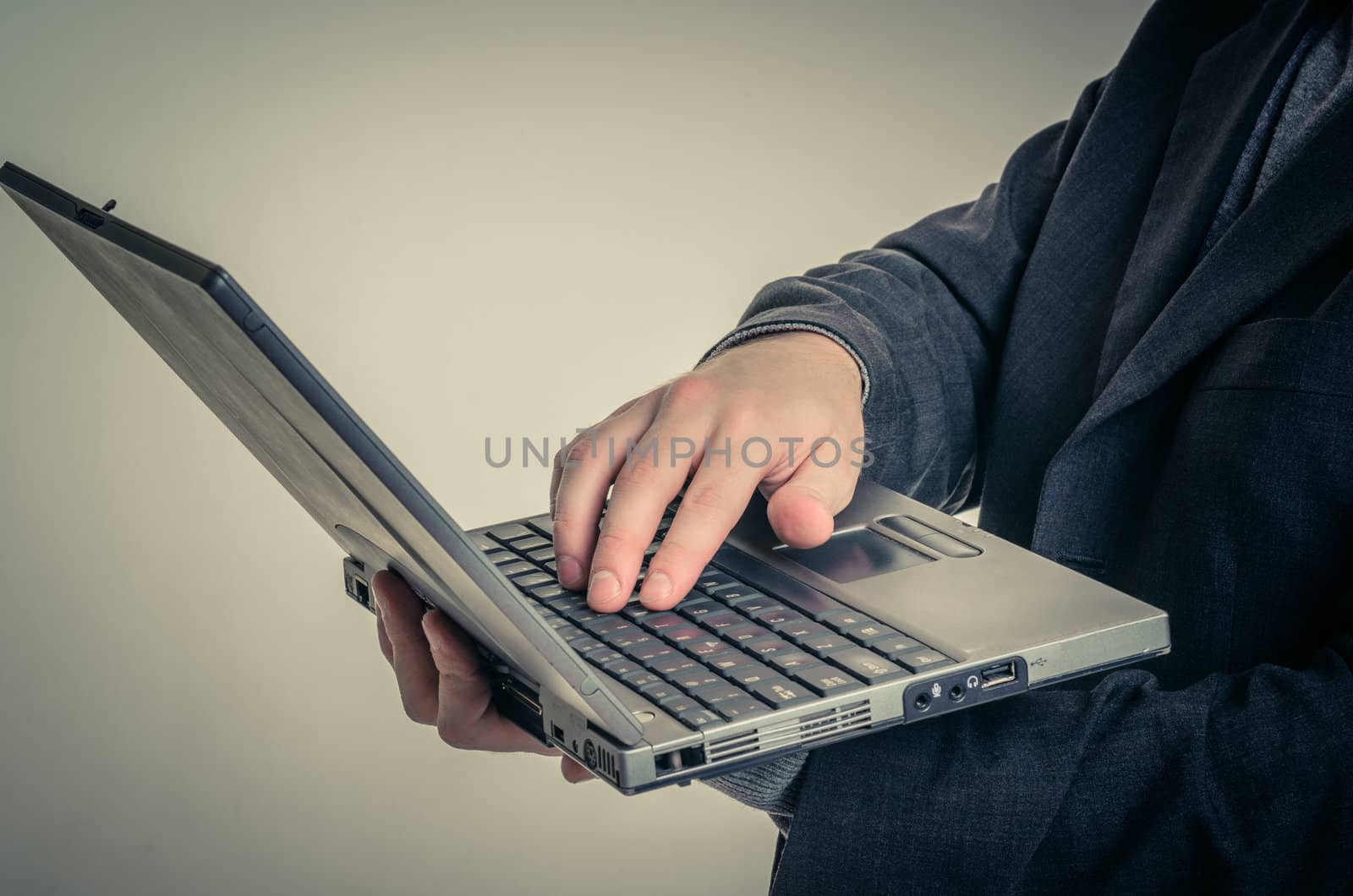 Young man in business suit against white background