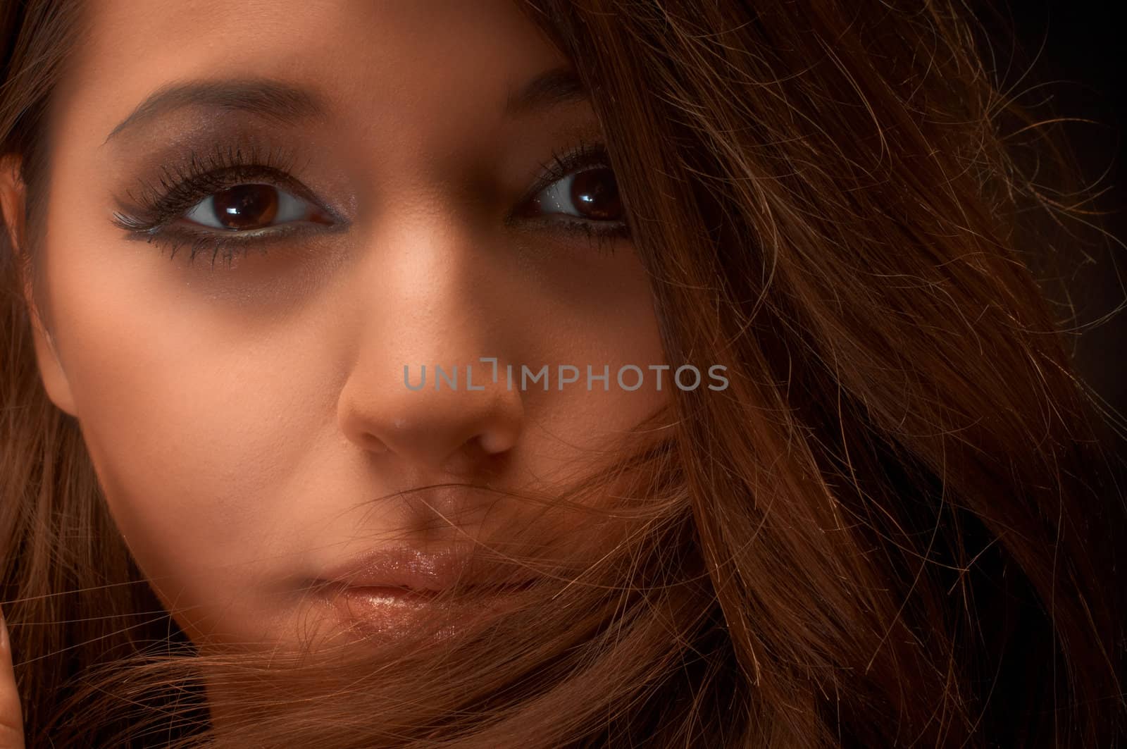 Artistic closeup photo of a young woman in studio