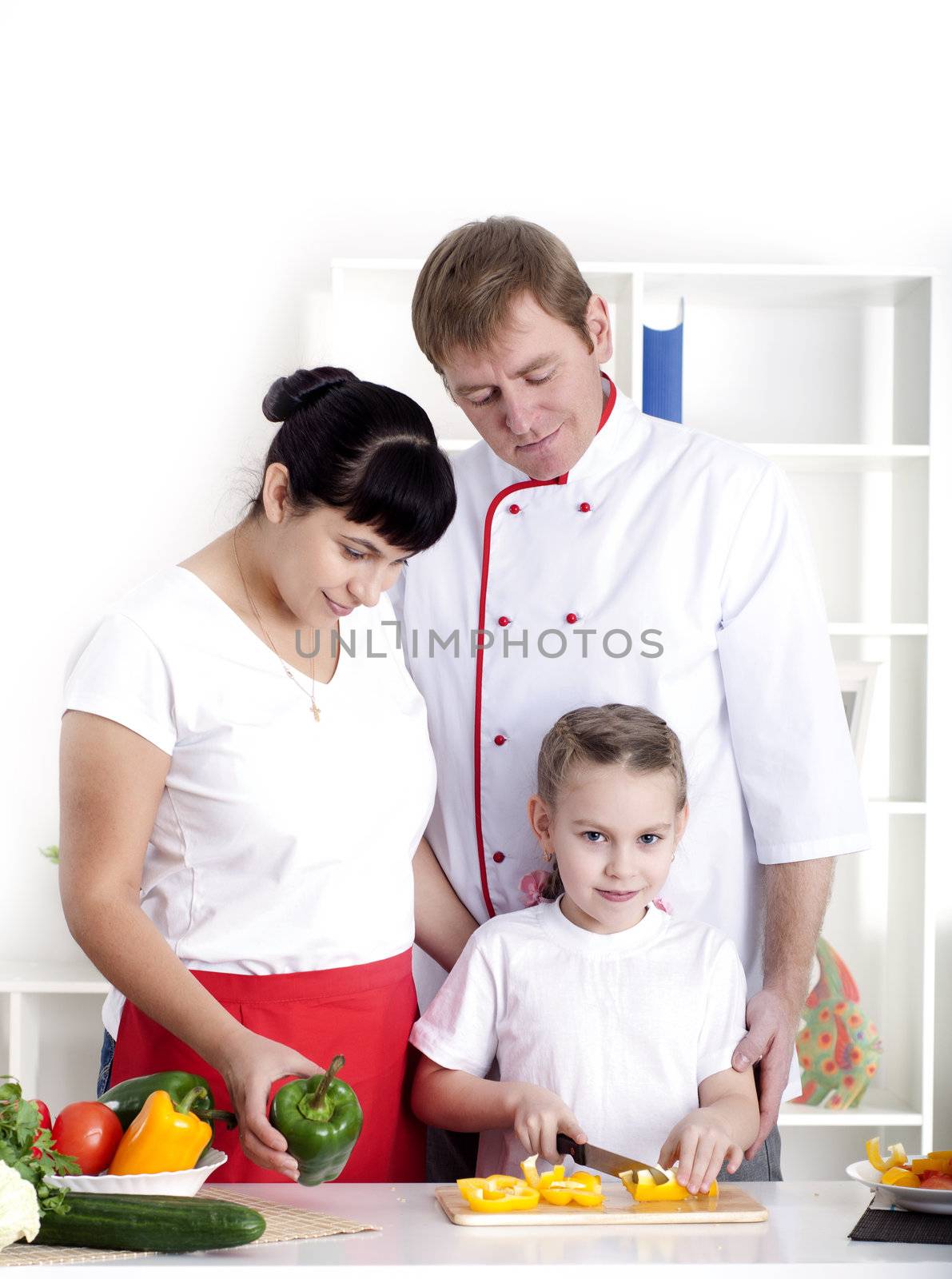 portrait happy family is cooking dinner together